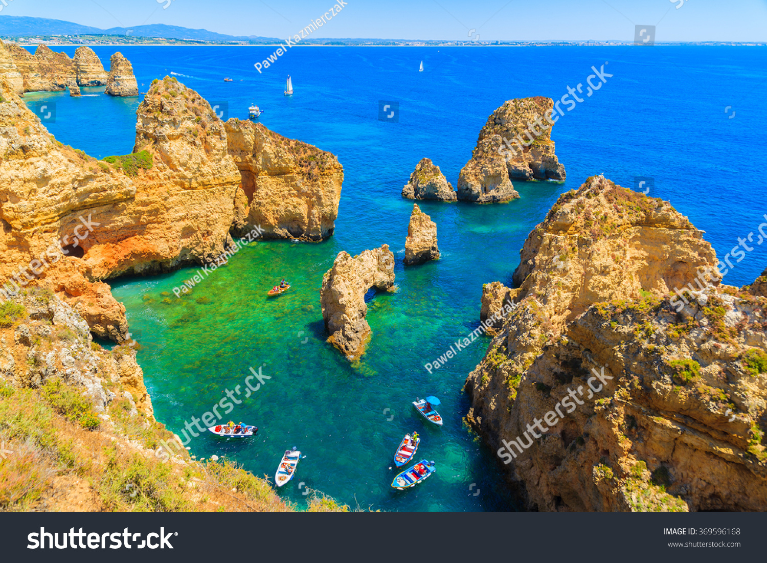 Fishing boats on turquoise sea water at Ponta da Piedade, Algarve region, Portugal #369596168