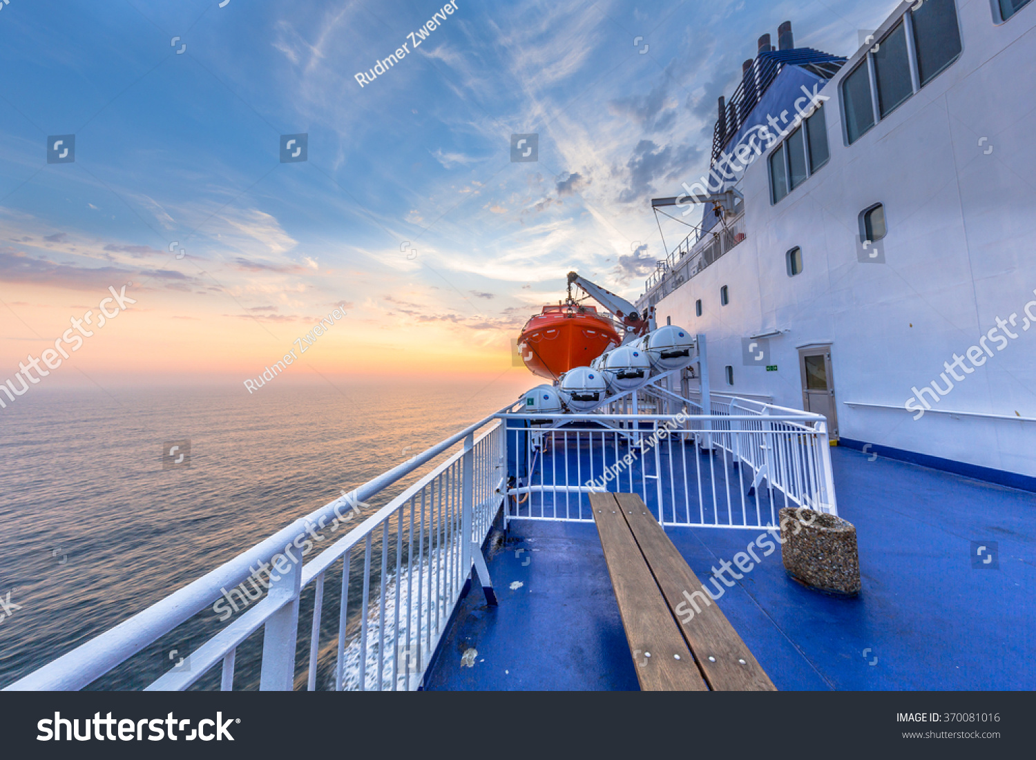 Deck on Ferry sailing across the Northsea during beautiful sunset #370081016