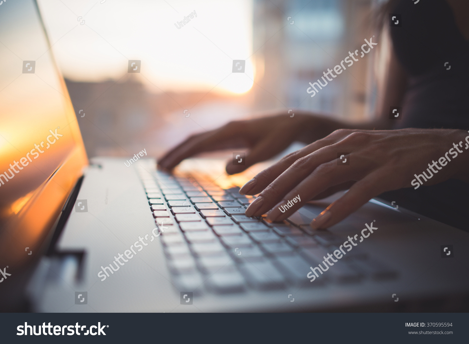 Woman working at home office hand on keyboard close up #370595594