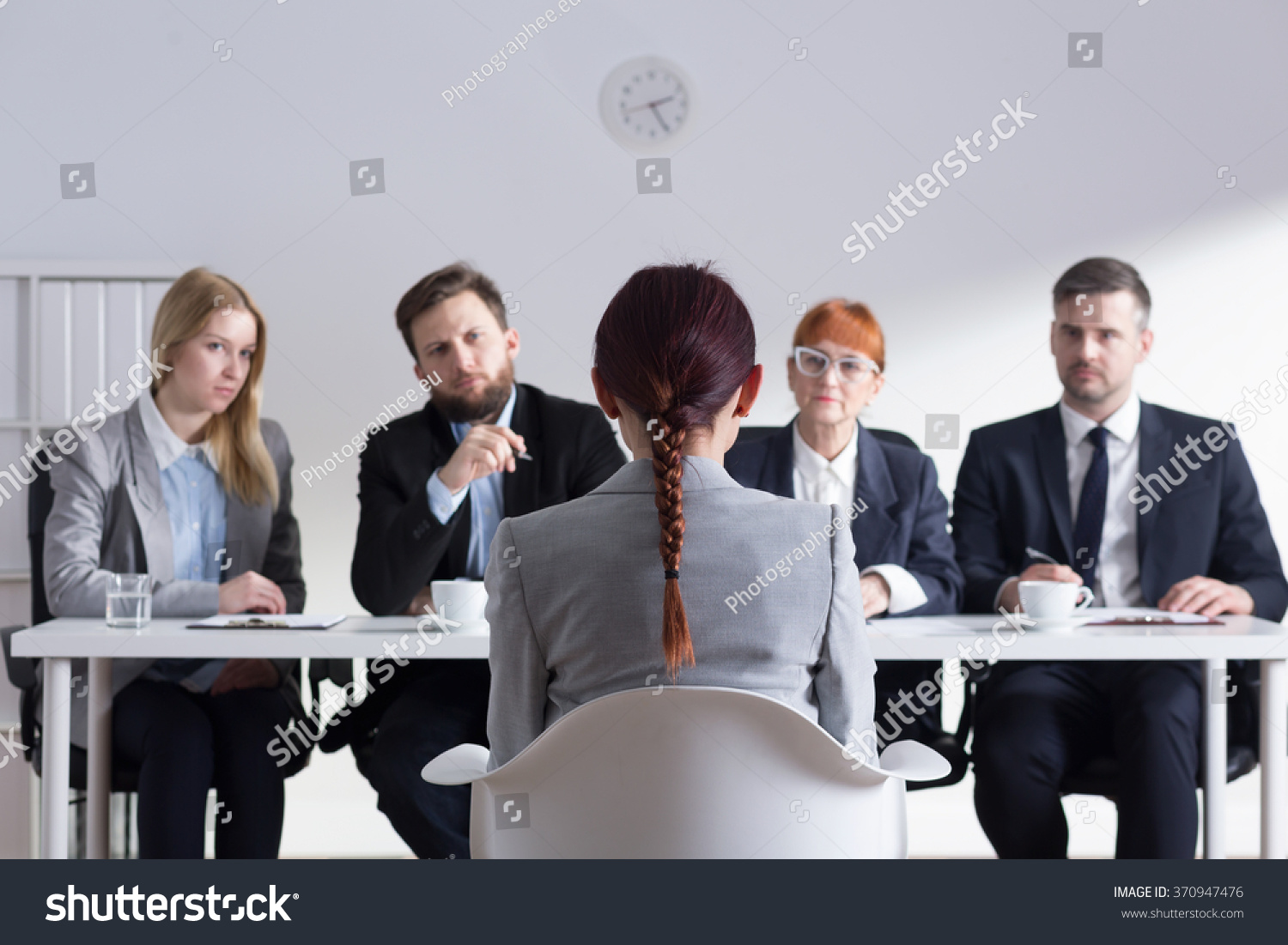 Woman during job interview and four elegant members of management #370947476
