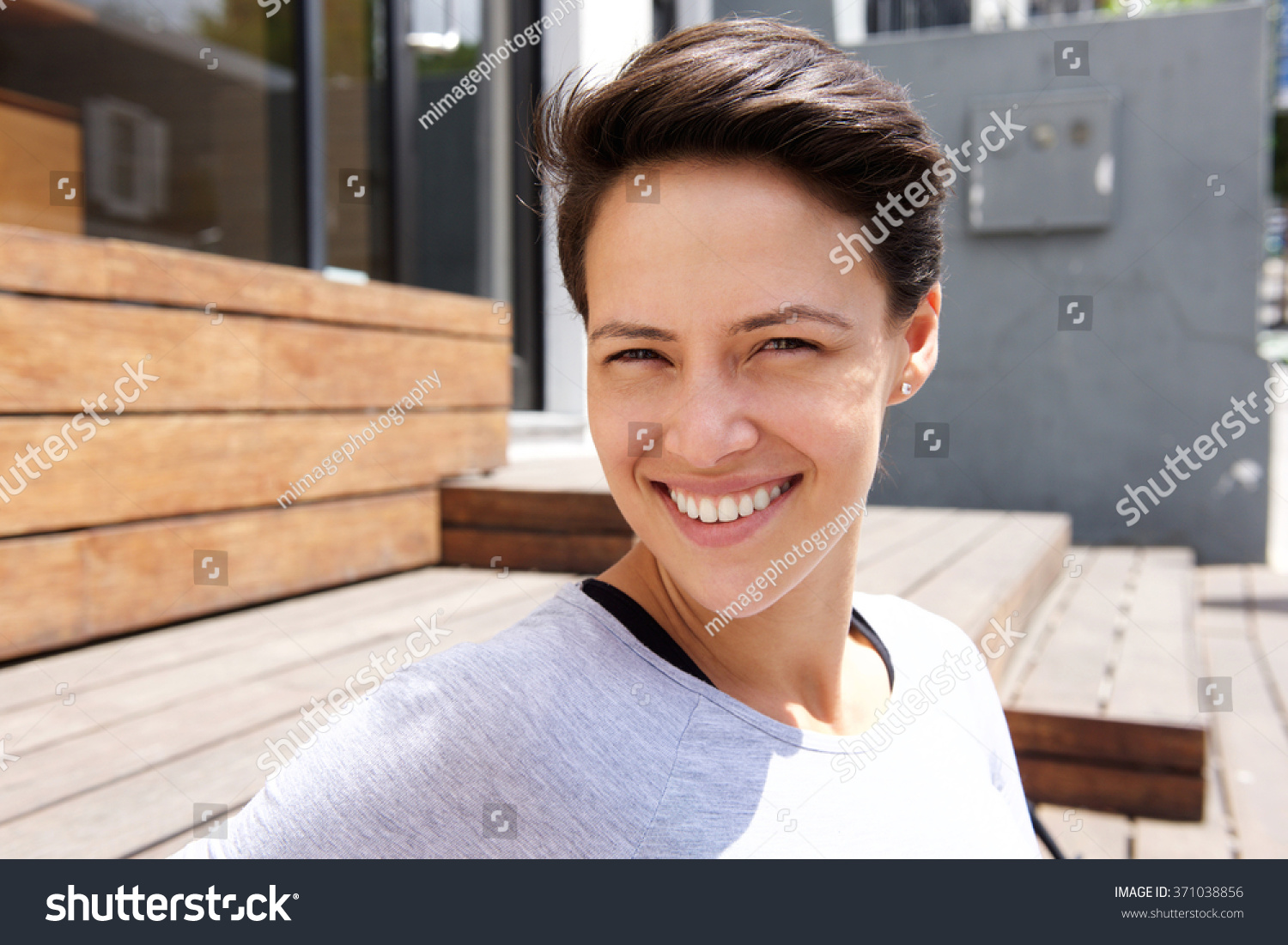 Close up portrait of a happy smiling young woman with short hair #371038856