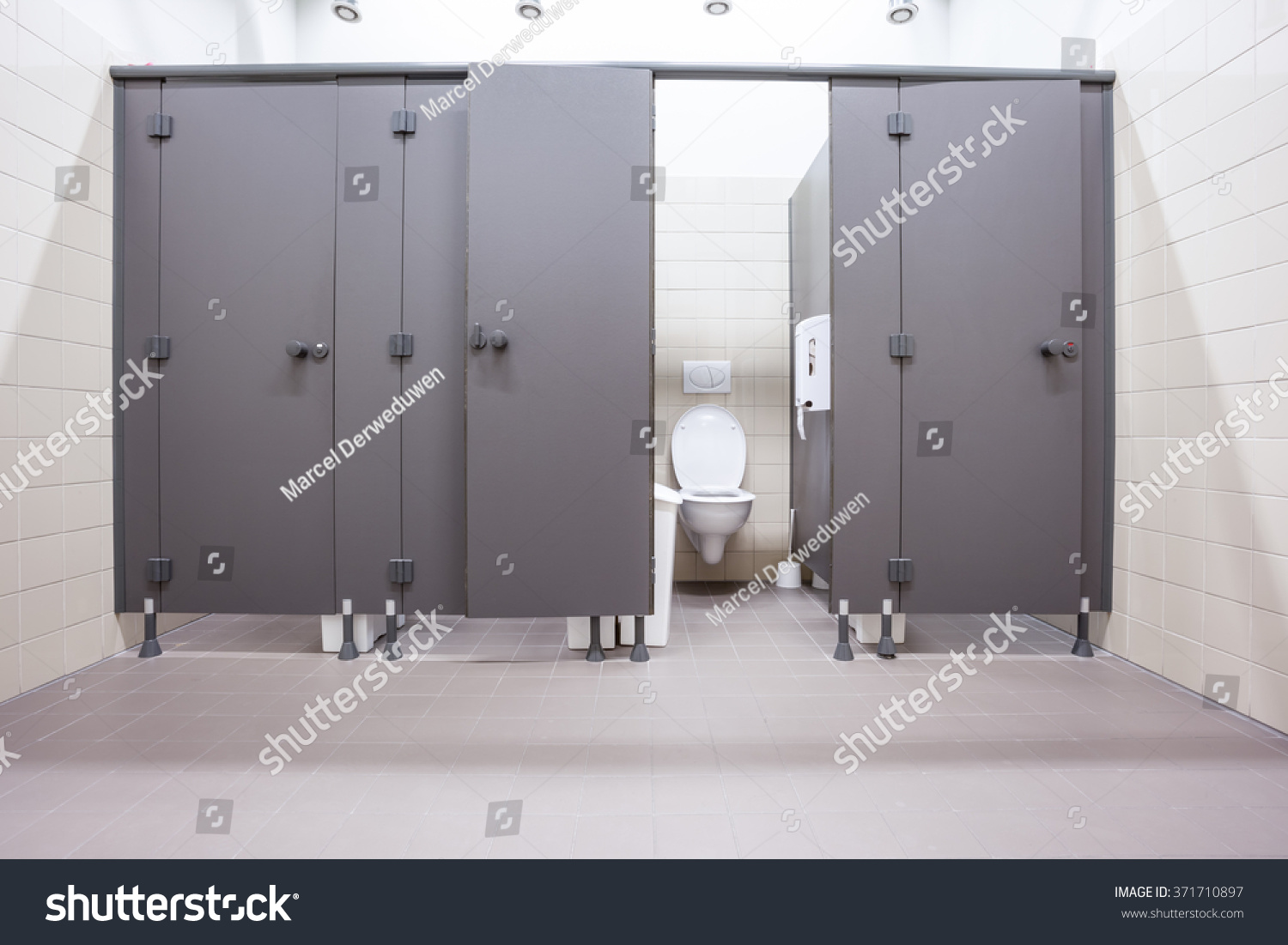 In an public building are womans toilets whit black doors #371710897