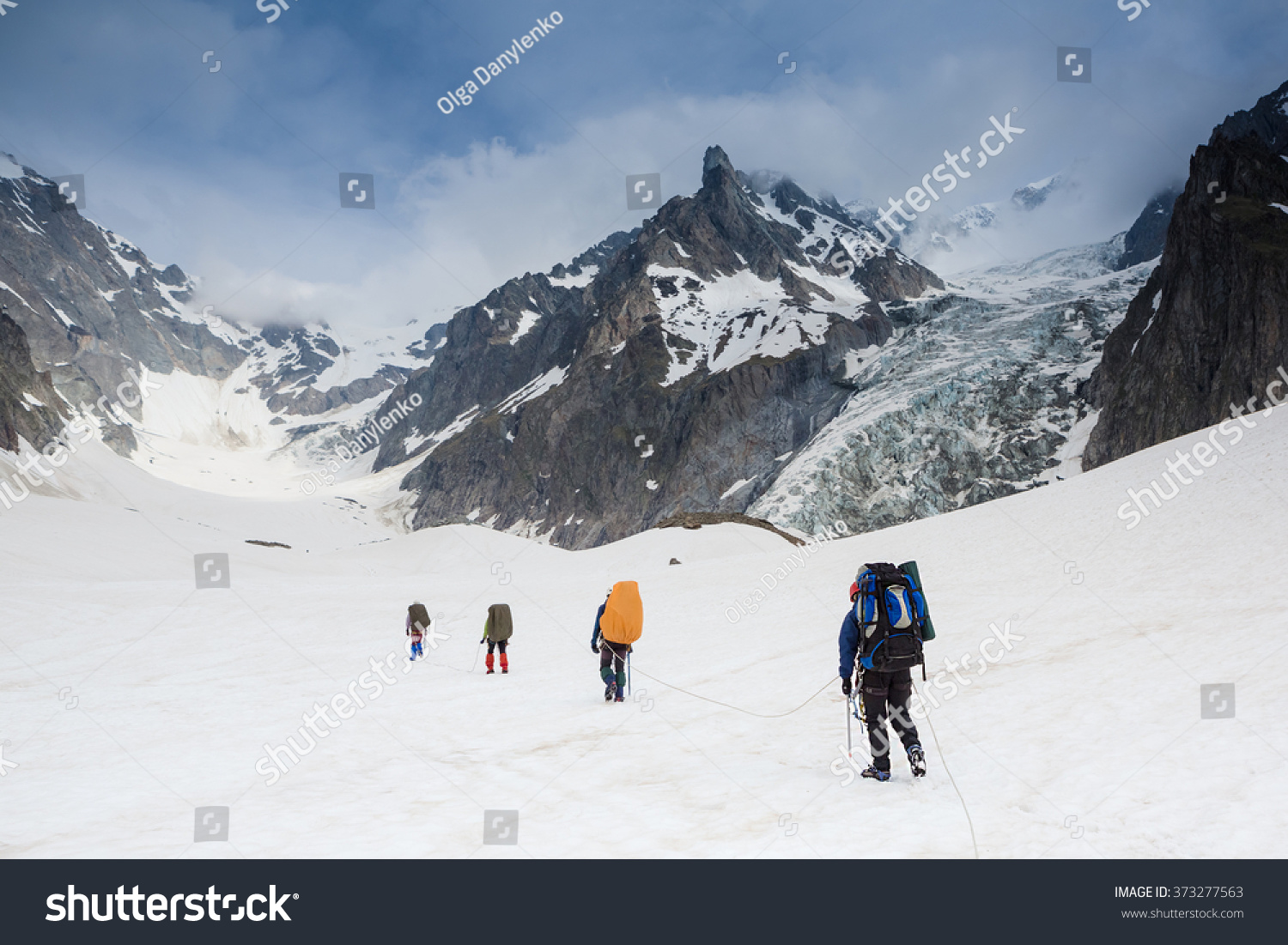 Tied climbers climbing mountain with snow field #373277563