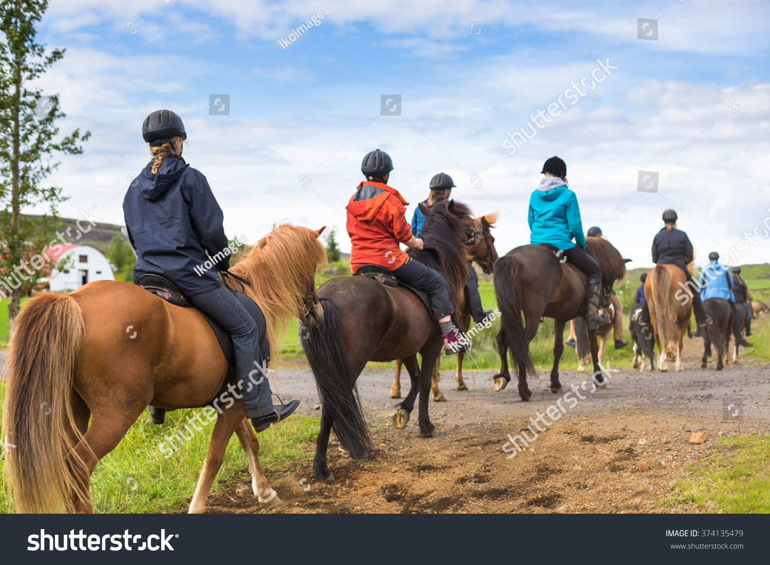 Group of horseback riders ride  in Iceland #374135479