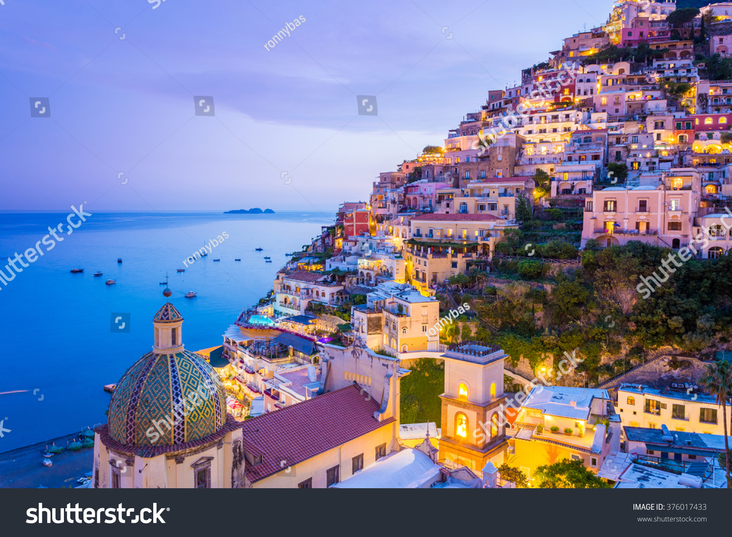 Positano, Amalfi Coast, Campania, Sorrento, Italy. View of the town and the seaside in a summer sunset #376017433