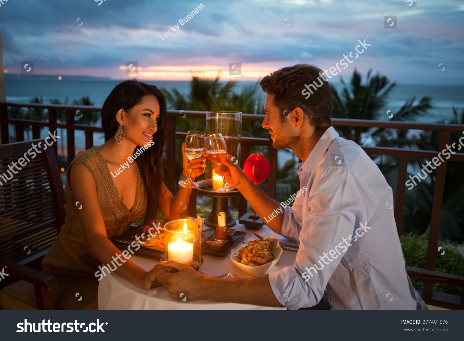 young couple enjoying a romantic dinner by candlelight, outdoor #377401576