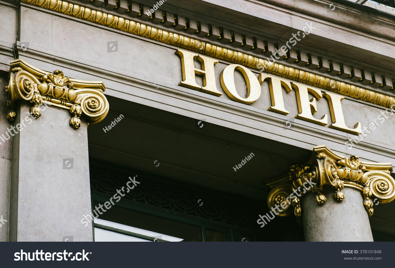 Hotel word with golden letters on luxury hotel with beautiful columns #378101848