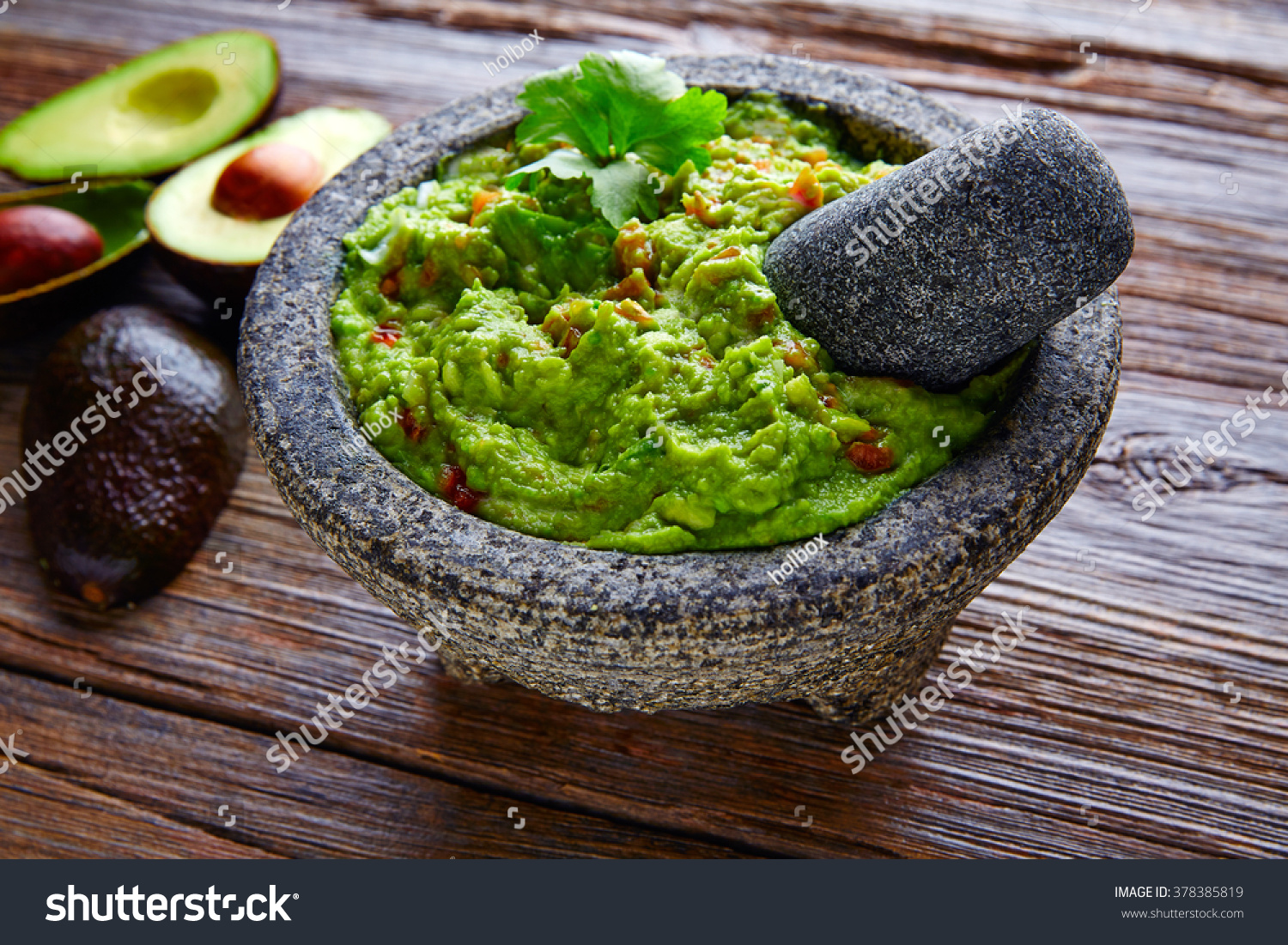 avocado Guacamole on molcajete real Mexican traditional procedure #378385819