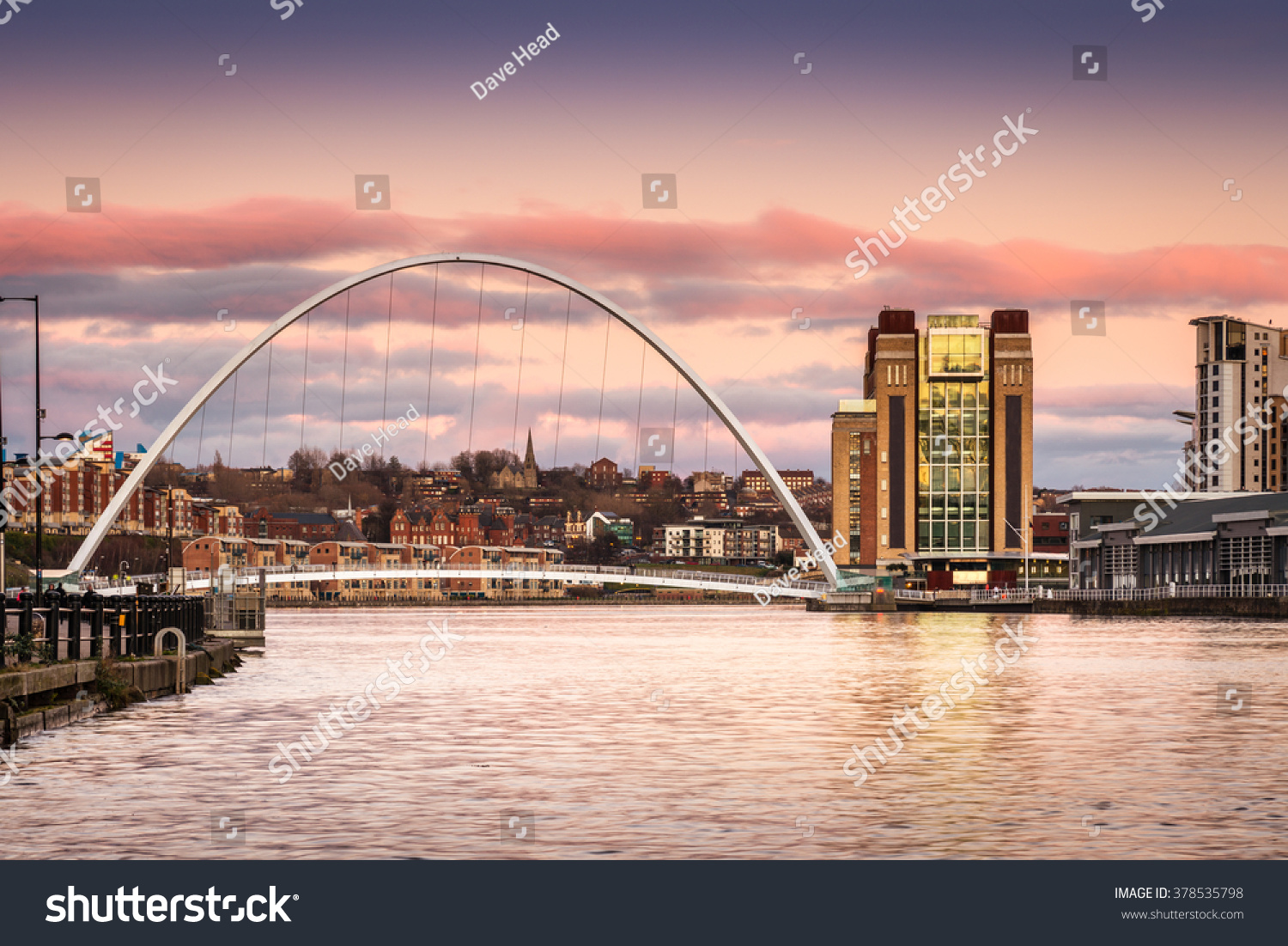 Millennium Bridge at sunset / The Iconic Millennium Bridge crosses the River Tyne joining the Quaysides of Newcastle and Gateshead for cycles and pedestrians #378535798