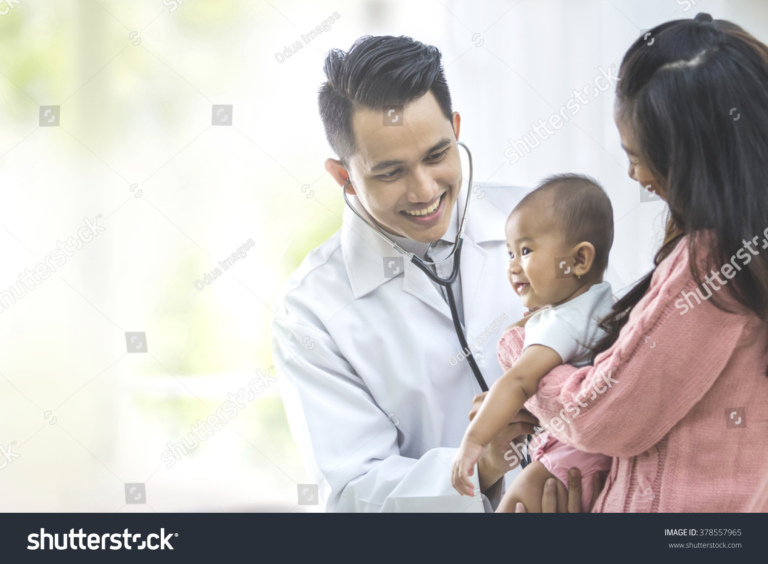 portrait of a baby being checked by a doctor using a stethoscope #378557965