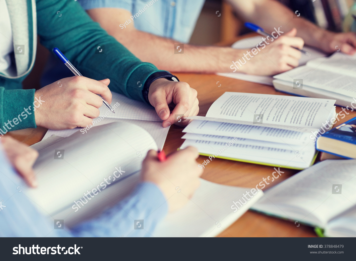 people, learning, education and school concept - close up of students hands with books or textbooks writing to notebooks #378848479