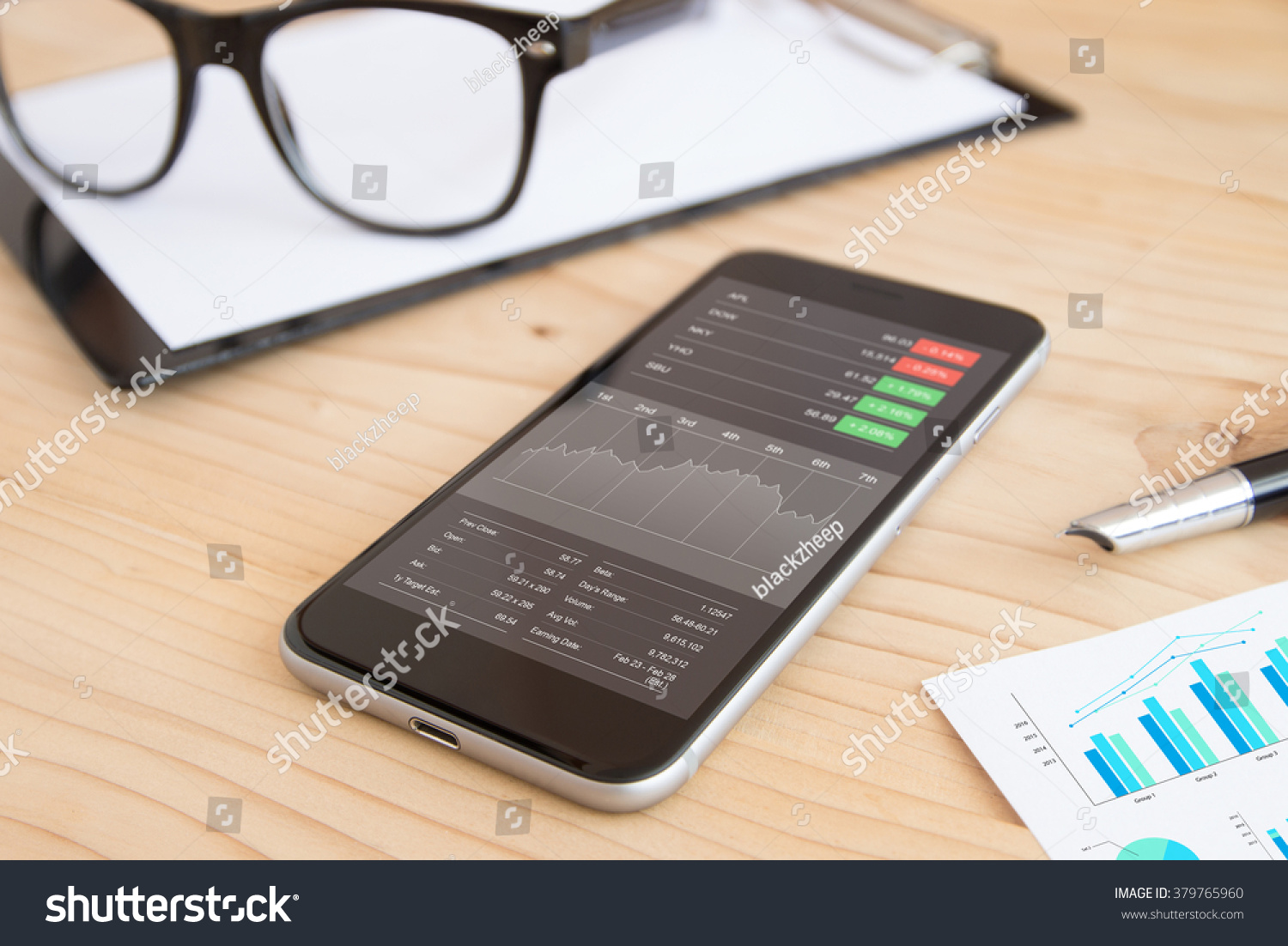phone and business stock application on work desk #379765960