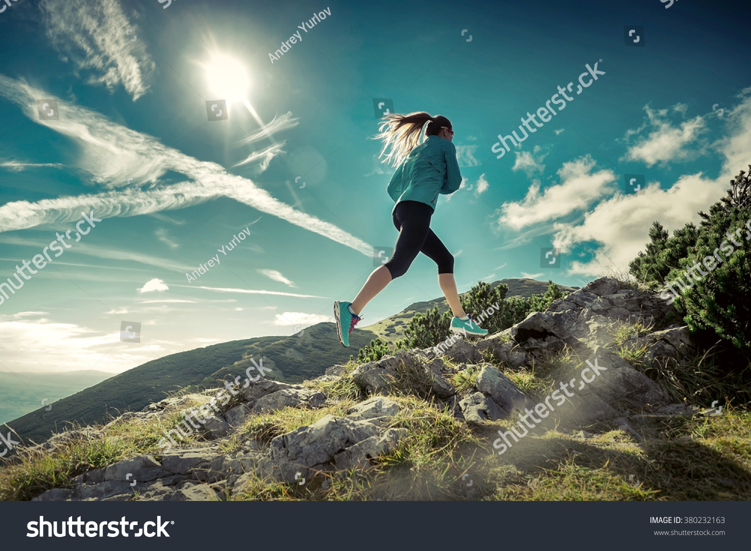 Female running in mountains under sunlight. #380232163