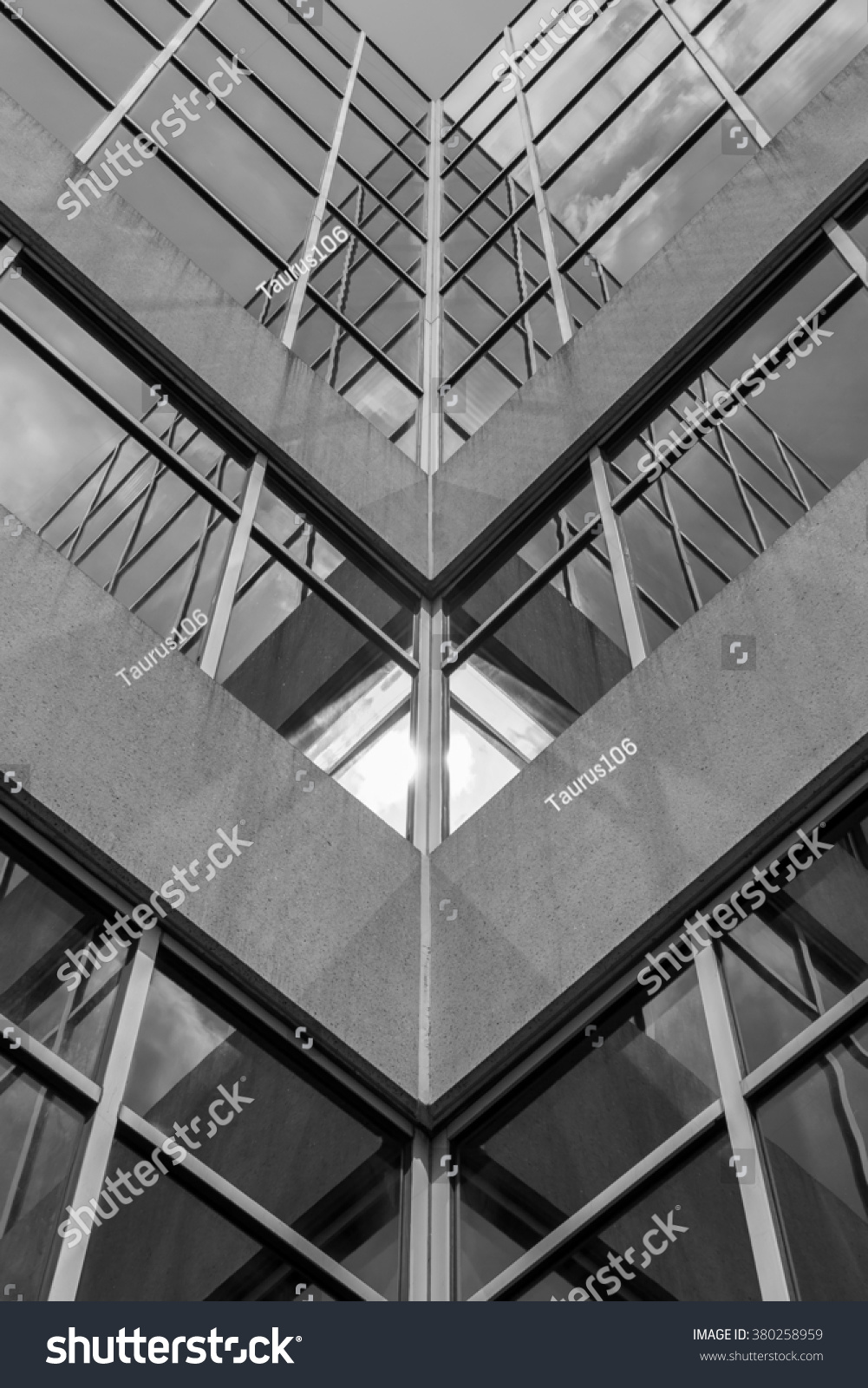 Urban Geometry, looking up to building. Modern architecture black and white, concrete and glass.  Abstract architectural design. Inspirational, artistic image BW. Artistic image and point of view. #380258959