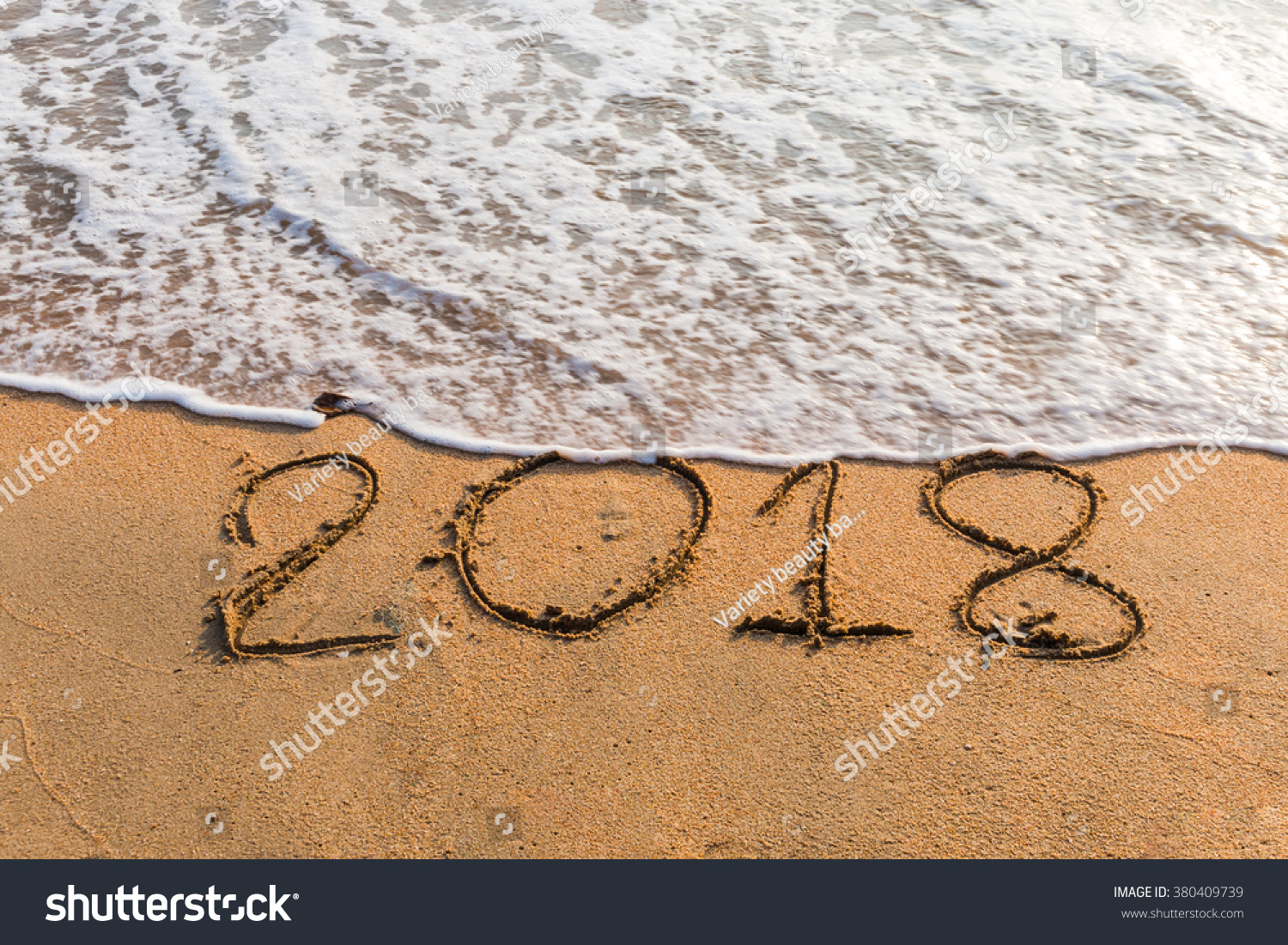 New Year 2018 is coming concept - write  2018 on a beach sand #380409739