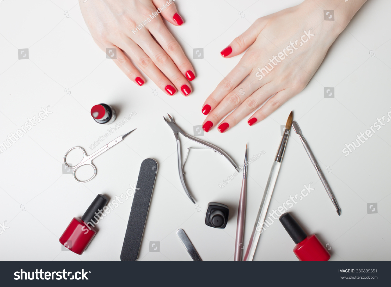 Manicure - Beautiful manicured woman's nails with red nail polish #380839351