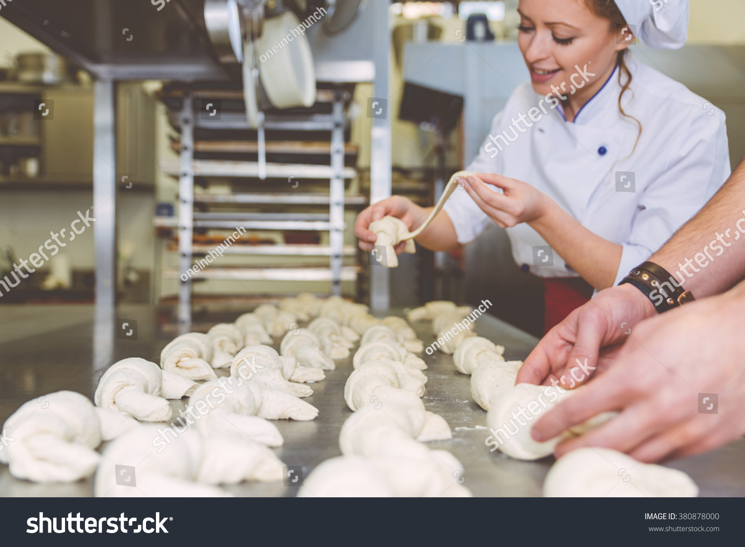 Chef preparing sweet croissant in the pastry shop laboratory. Industrial concept about food. Focus on the sweets #380878000