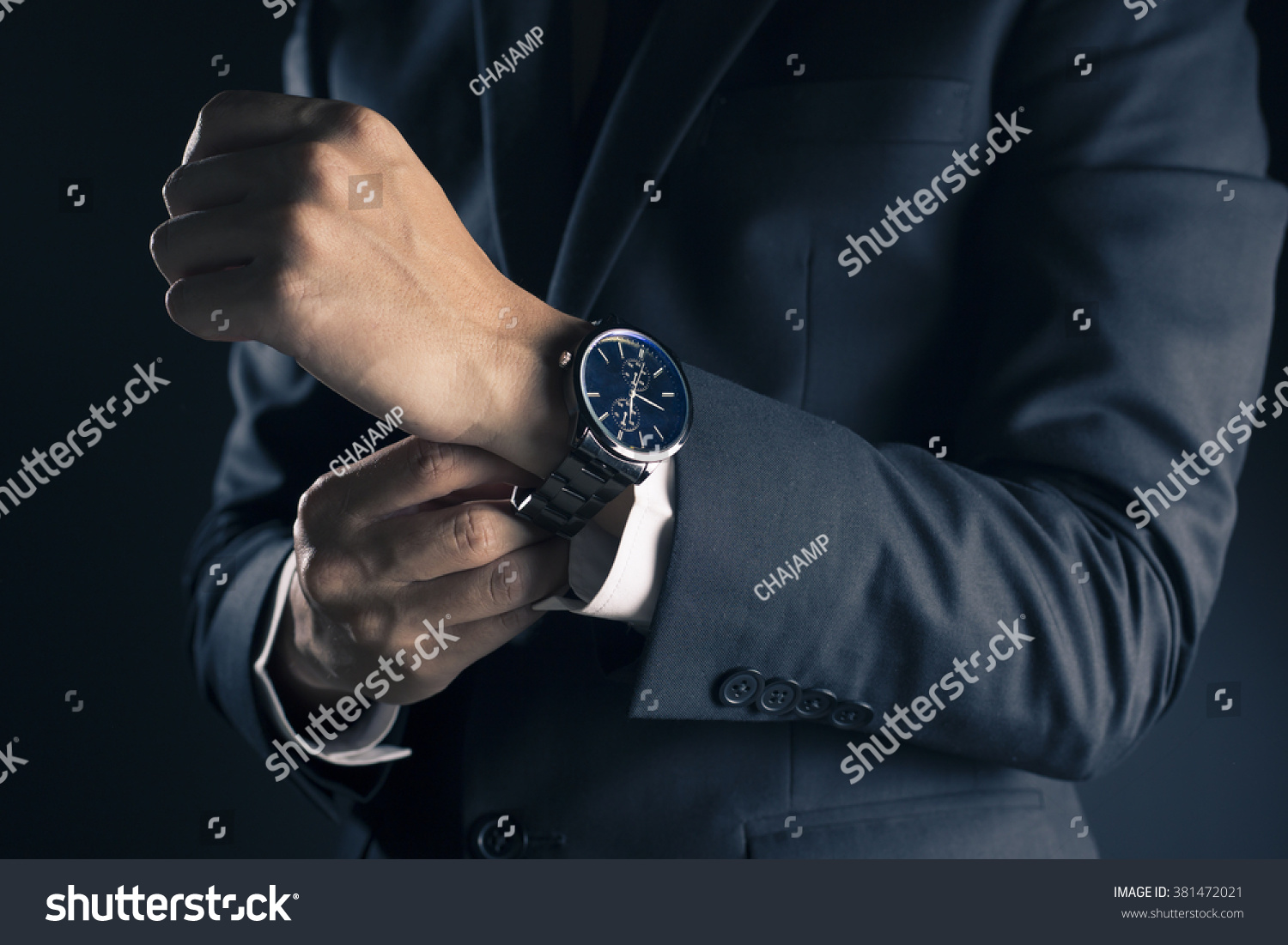 Businessman checking time from watch #381472021