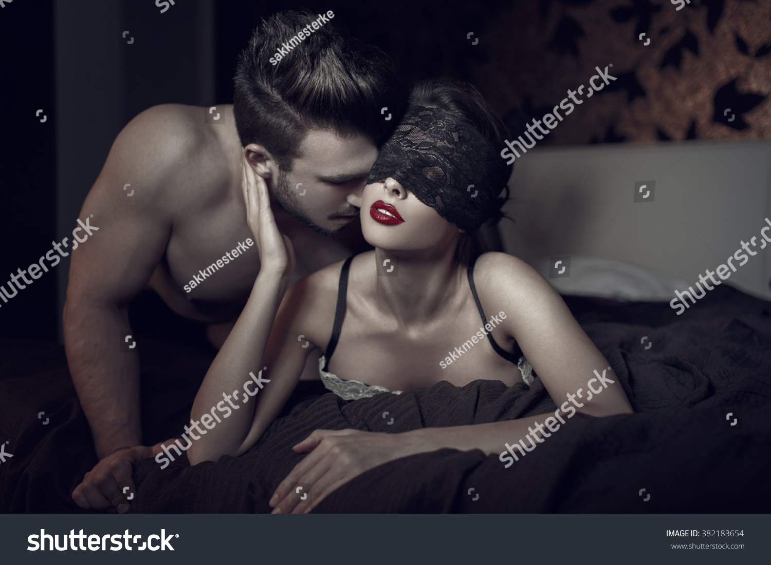 Sexy woman in lace eye cover and red lips with young lover, foreplay  #382183654