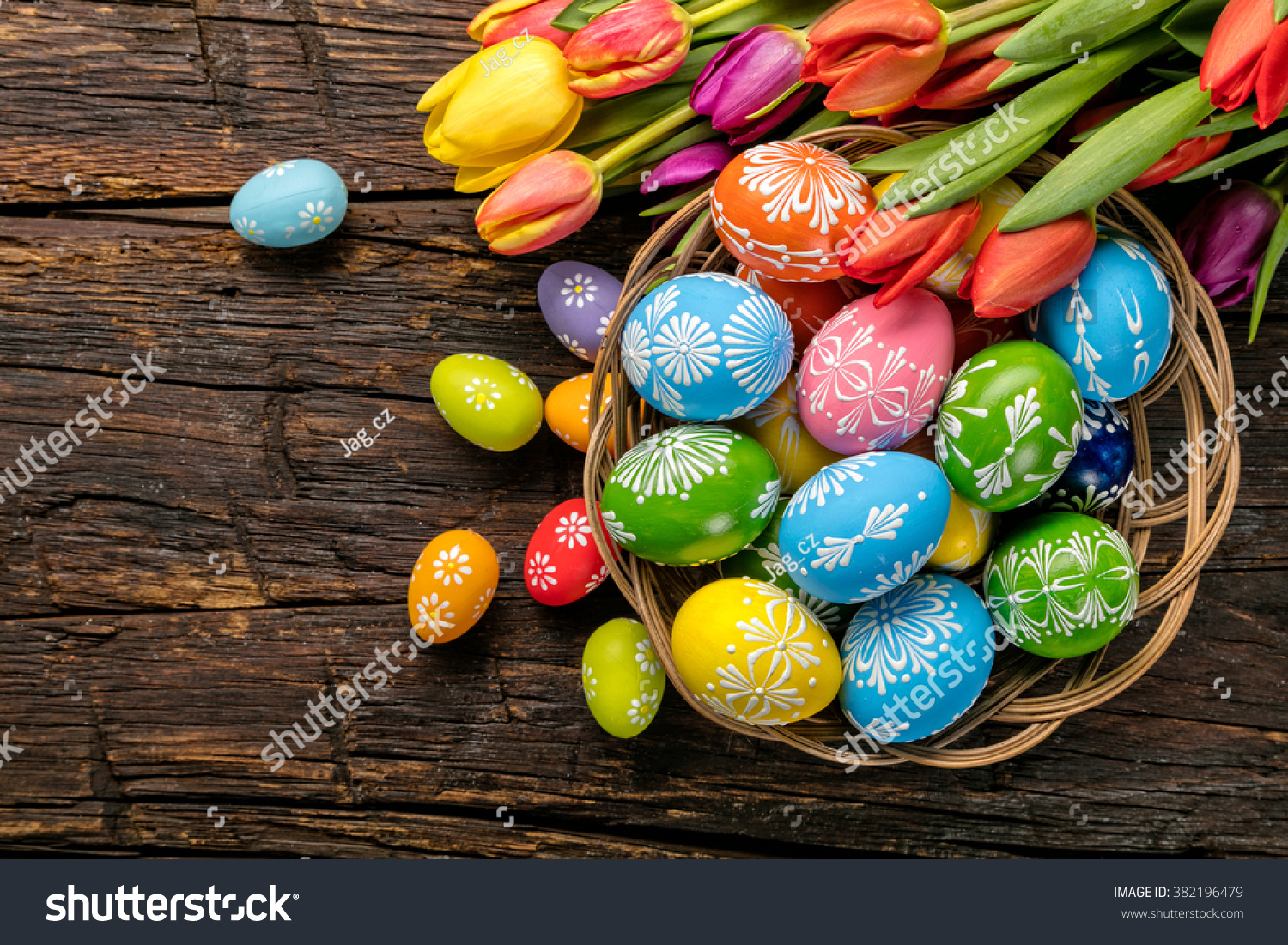 Easter eggs and tulips on wooden planks #382196479
