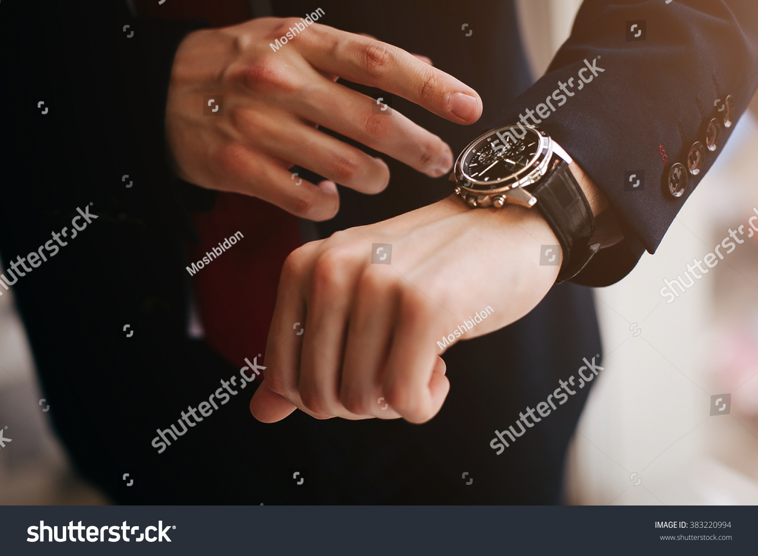 closeup designer watch on businessman hand, he looks on the time and hurrying #383220994