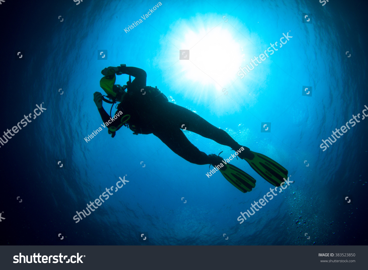 Silhouette of a beautiful female diver at shallow water- #383523850