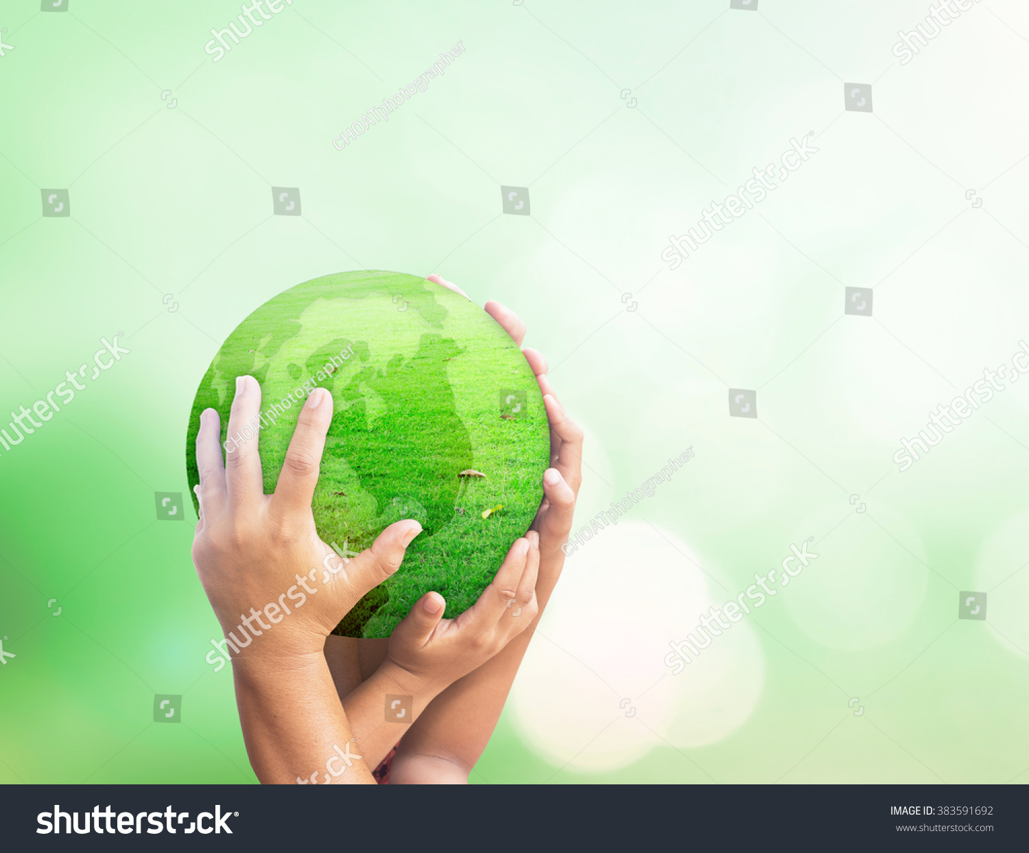World environment day concept: Many people hands holding earth globe of grass over blurred green nature background #383591692
