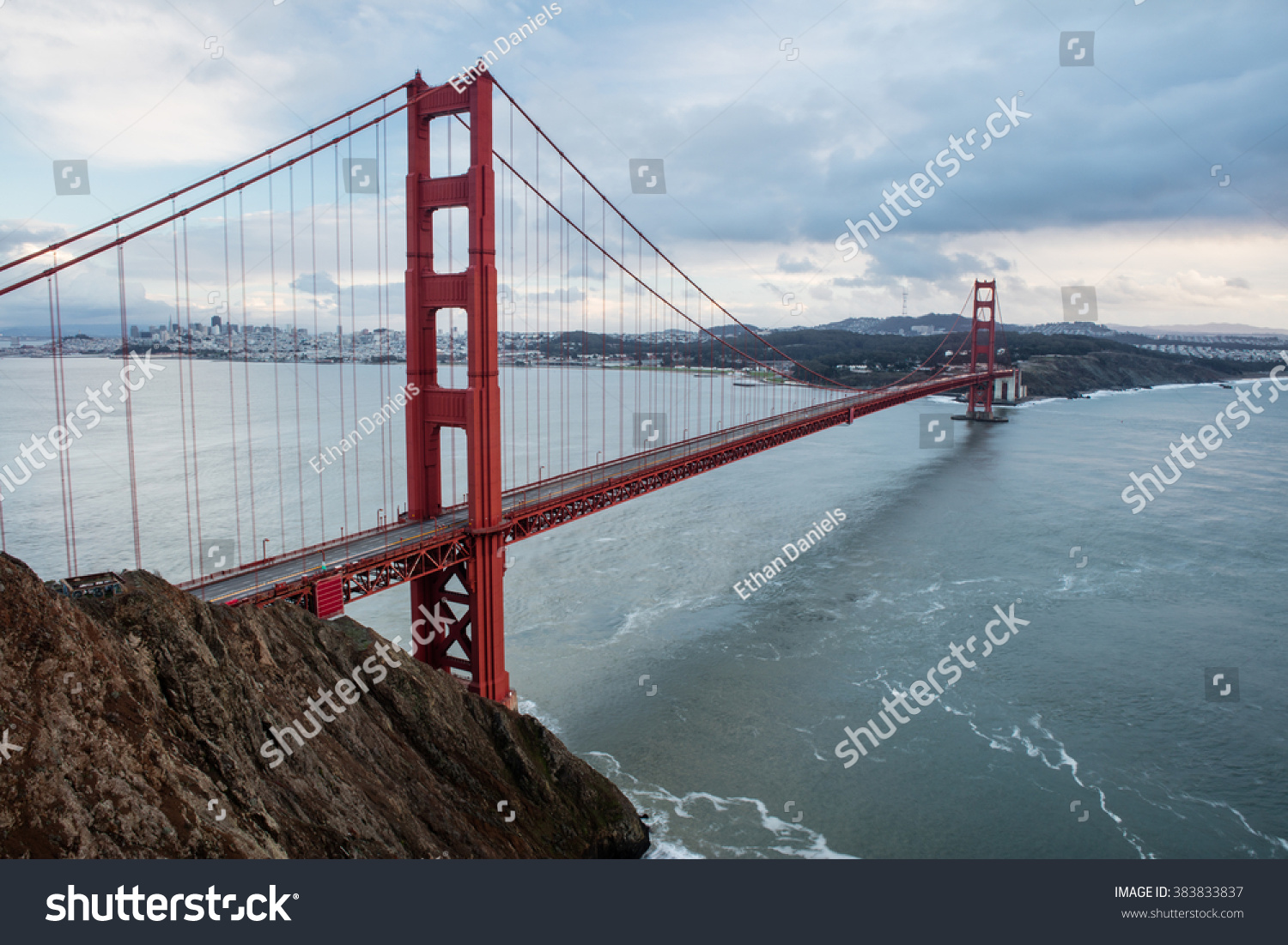 The iconic Golden Gate bridge extends across the San Francisco Bay from the Marin headlands to the beautiful city of San Francisco. The bridge is a symbol of the city and northern California. #383833837
