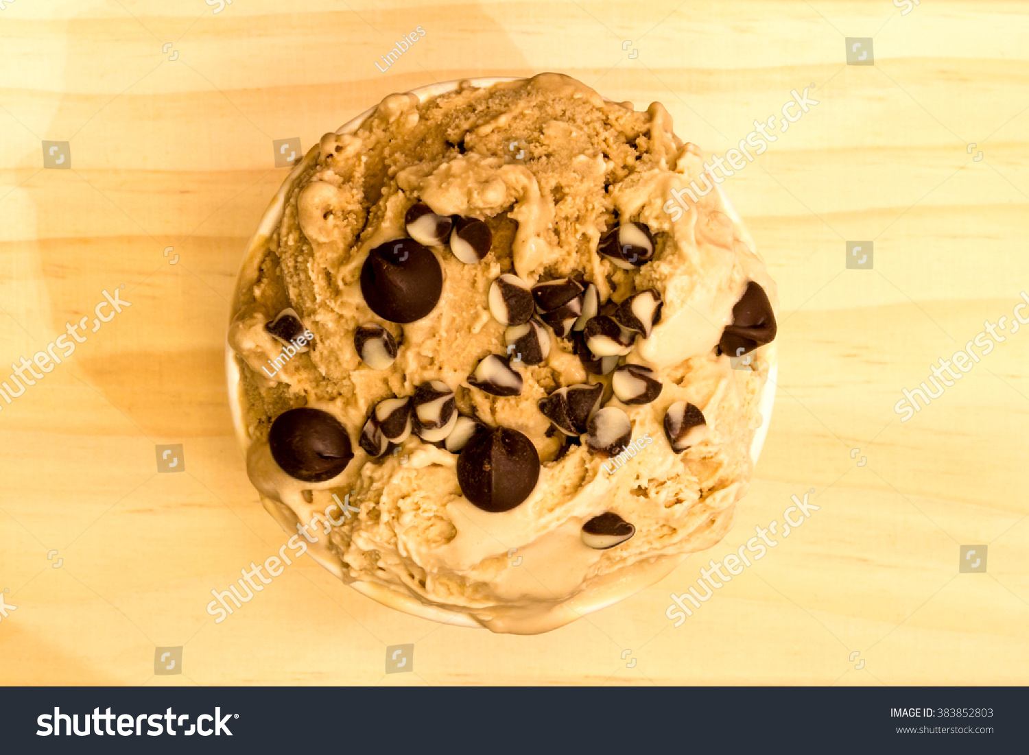 top view of coffee flavor icecream with topping with chocolate chips on the soft wooden background #383852803