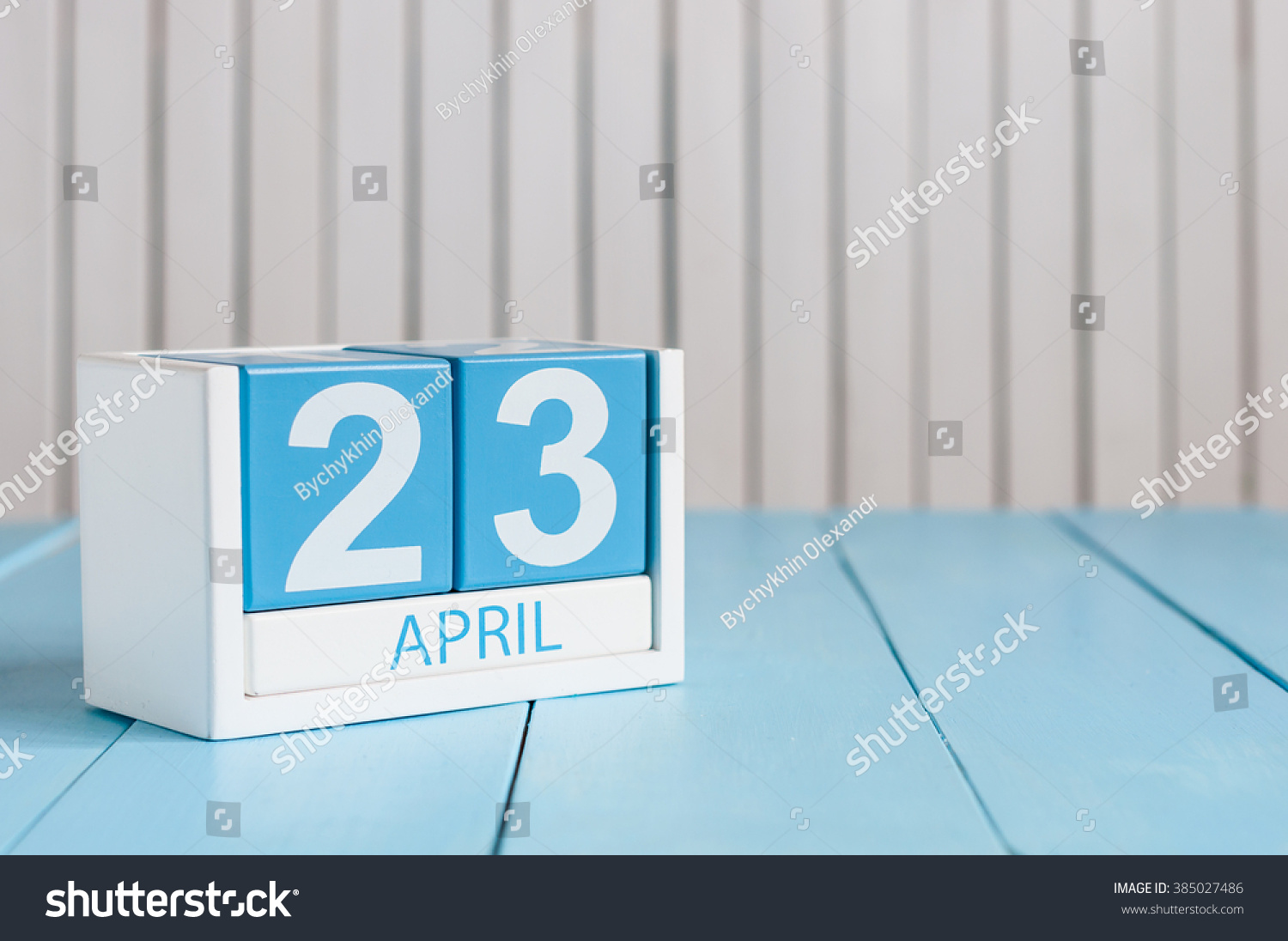 April 23rd. World Book Day. Image of april 23 wooden color calendar on white background.  Spring day, empty space for text #385027486