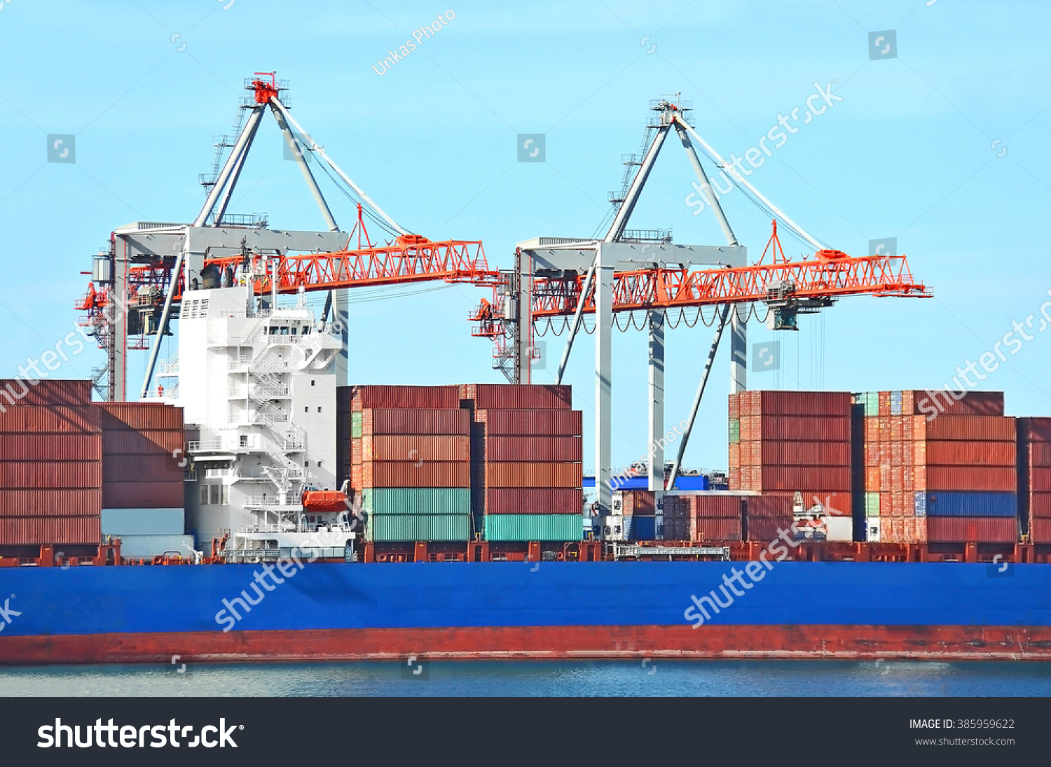 Container stack and ship under crane bridge #385959622