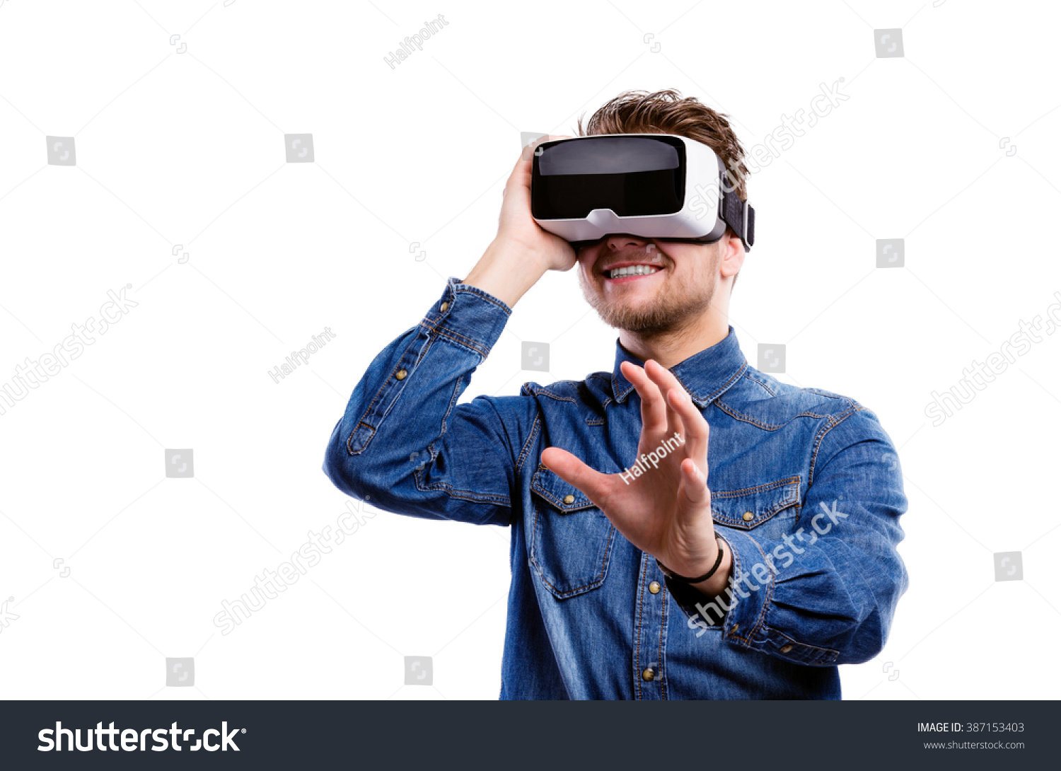 Man wearing virtual reality goggles. Studio shot, white backgrou #387153403