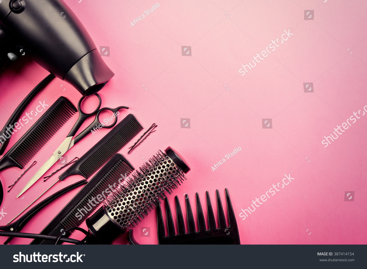 Hairdresser set with various accessories on pink background #387414154