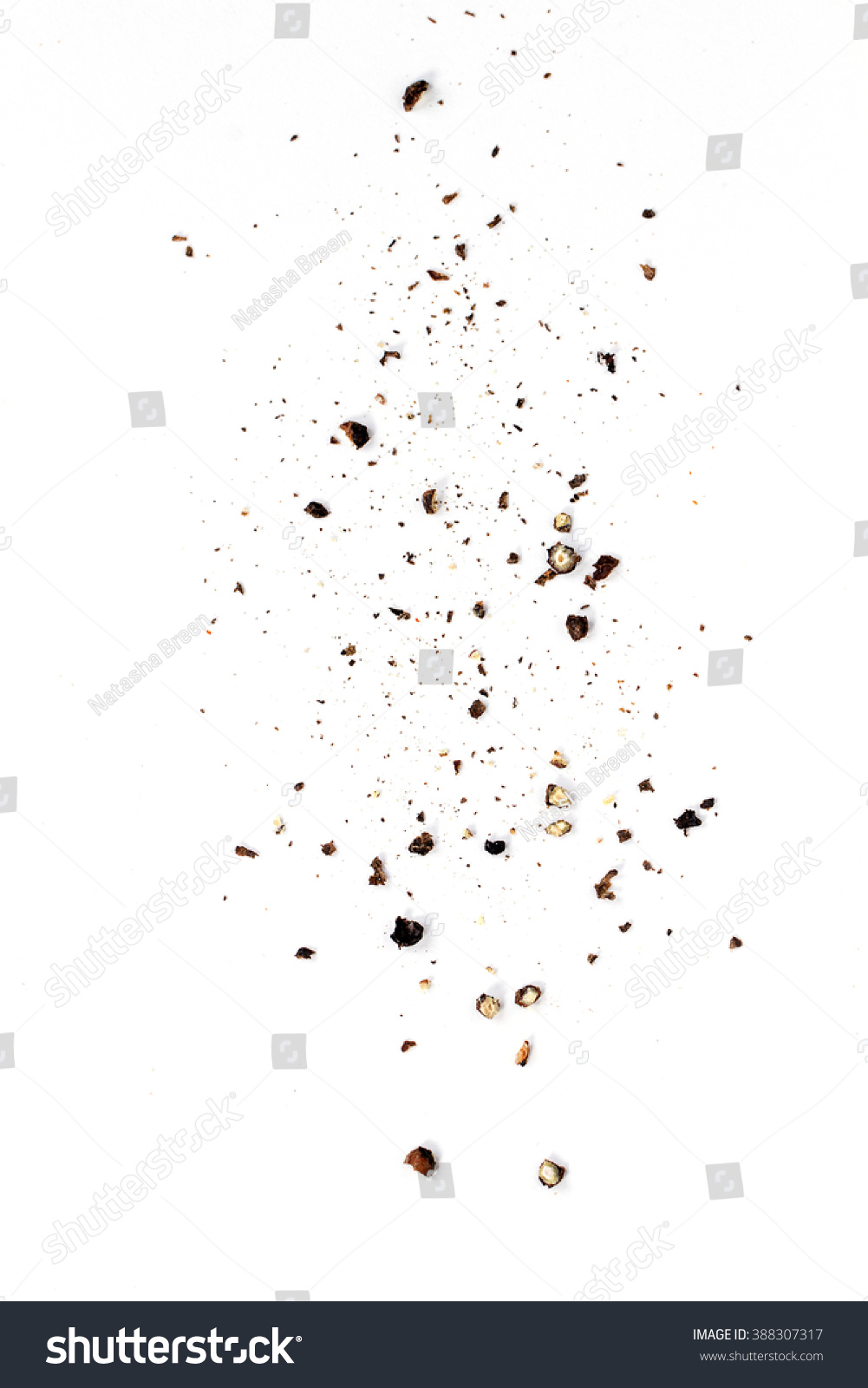 Sifting heavy ground black pepper over white background. #388307317