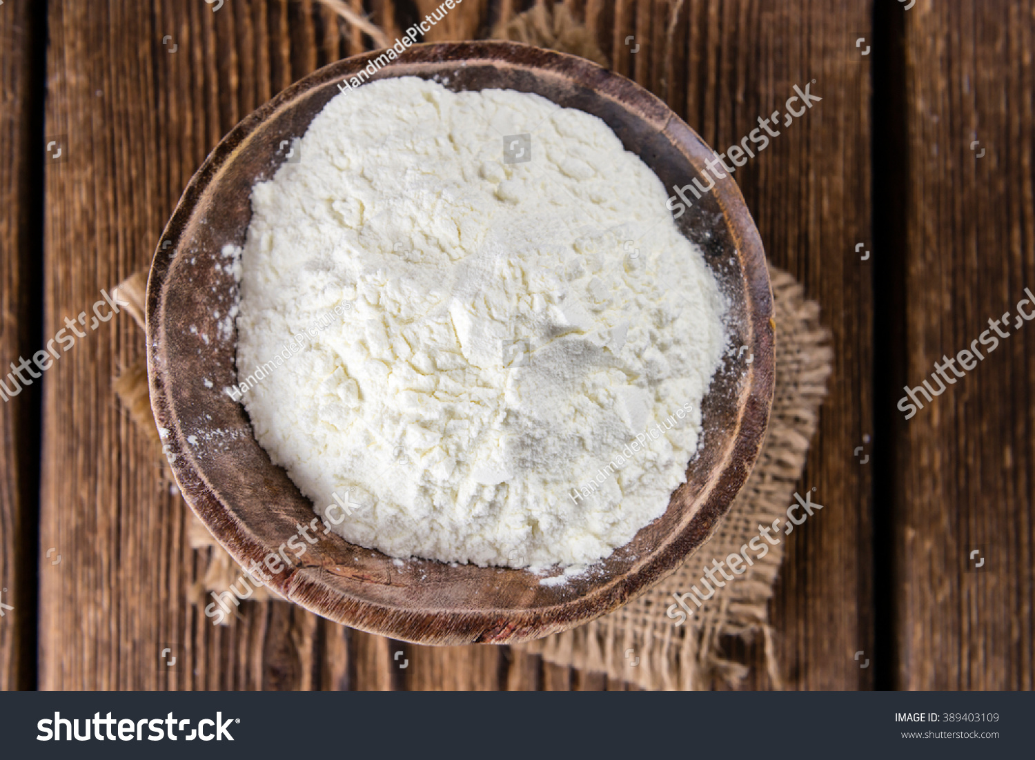Portion of Milk Powder (selective focus) on an old wooden table #389403109