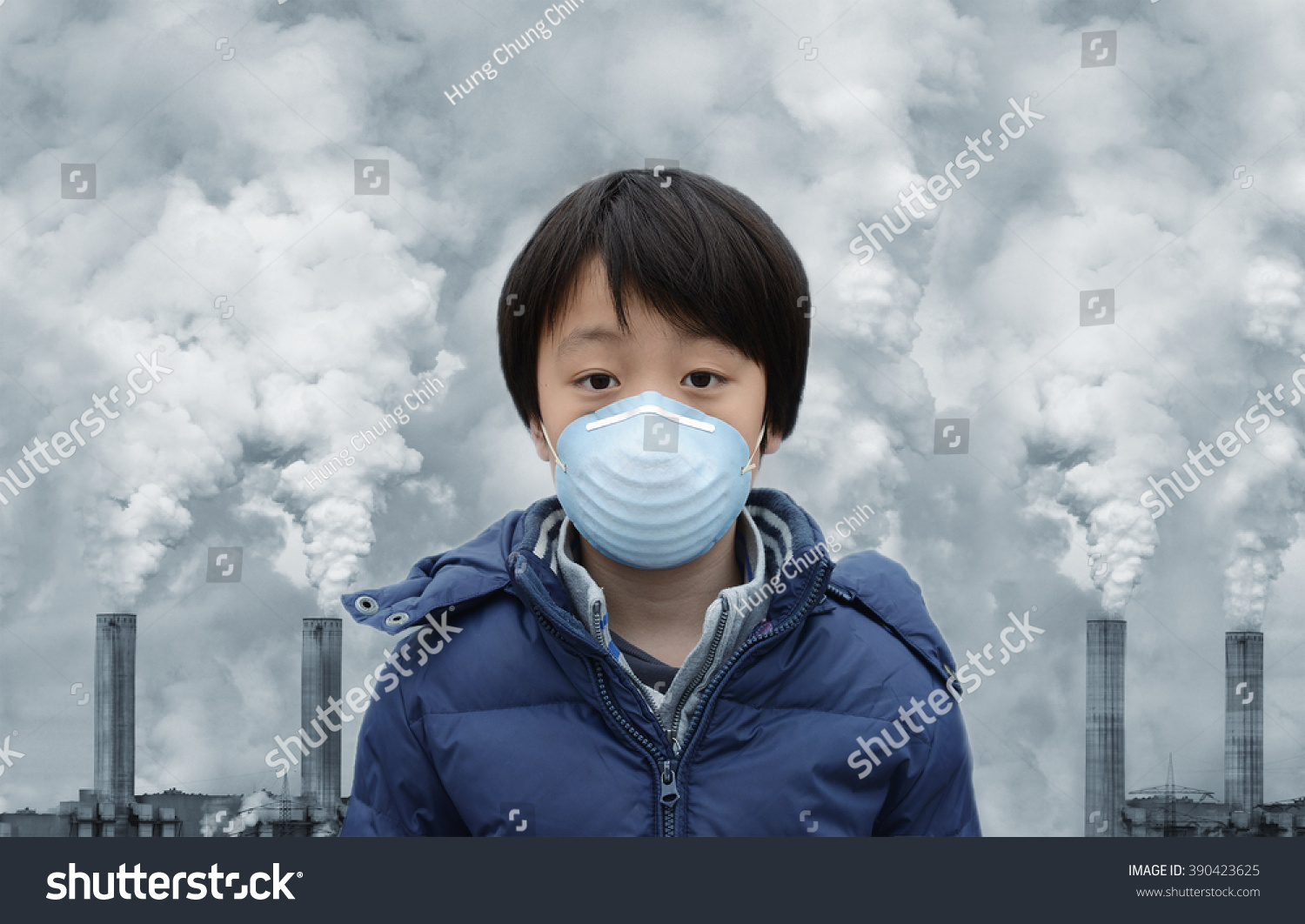 Asian boy wearing mouth mask against air pollution #390423625