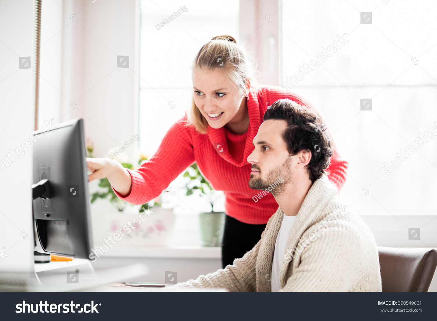 Couple working in home office with phone and computer #390549601