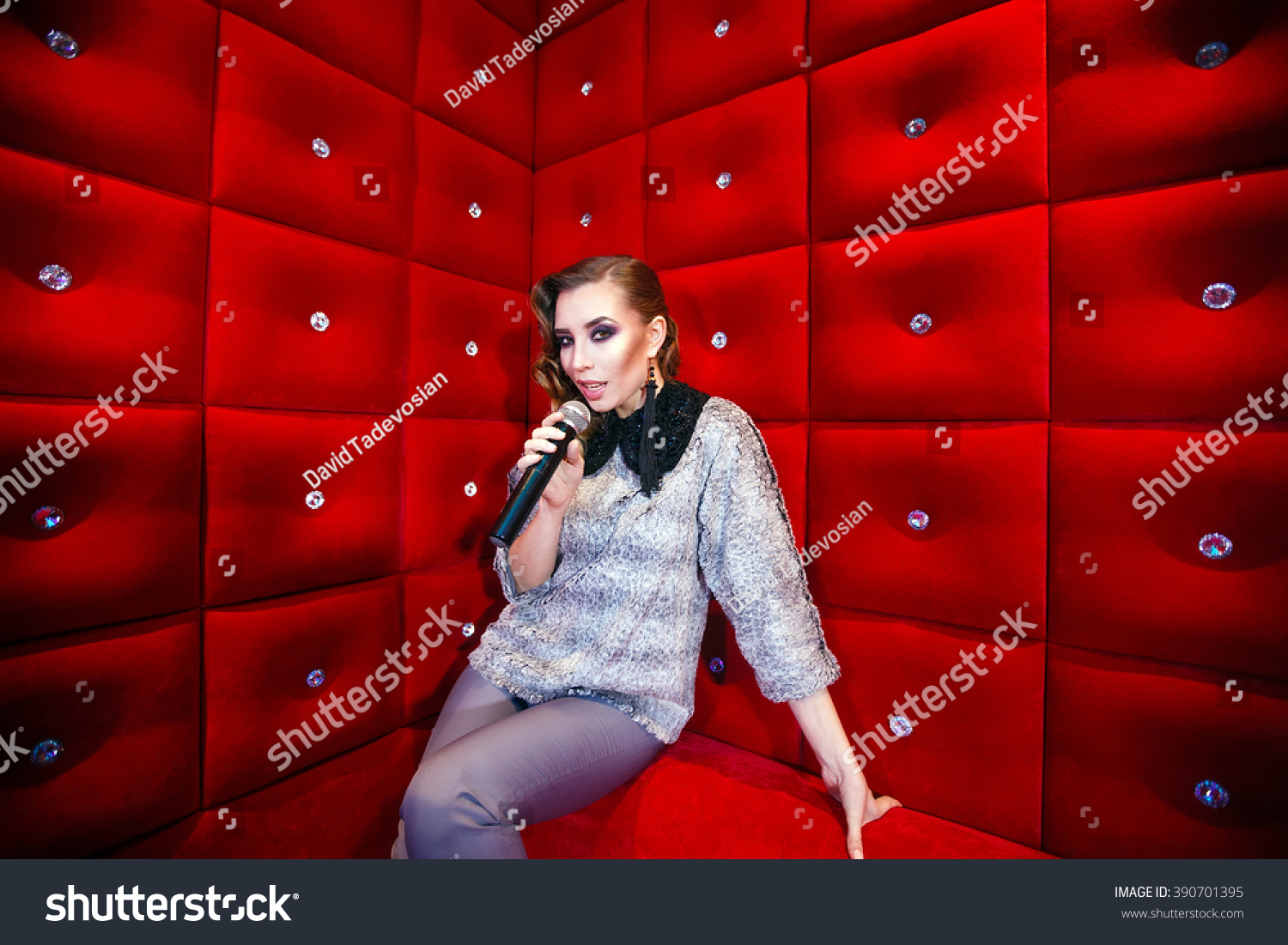 beautiful girl singing karaoke in a nightclub #390701395