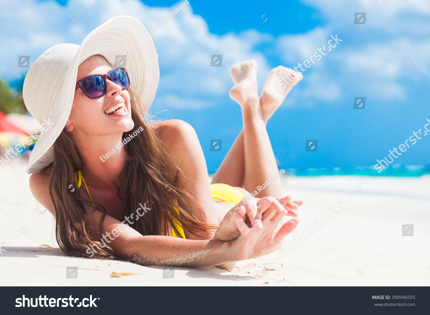 woman in bikini and sun hat relaxing at sunny beach. remote tropical beaches and countries. travel concept #390946555