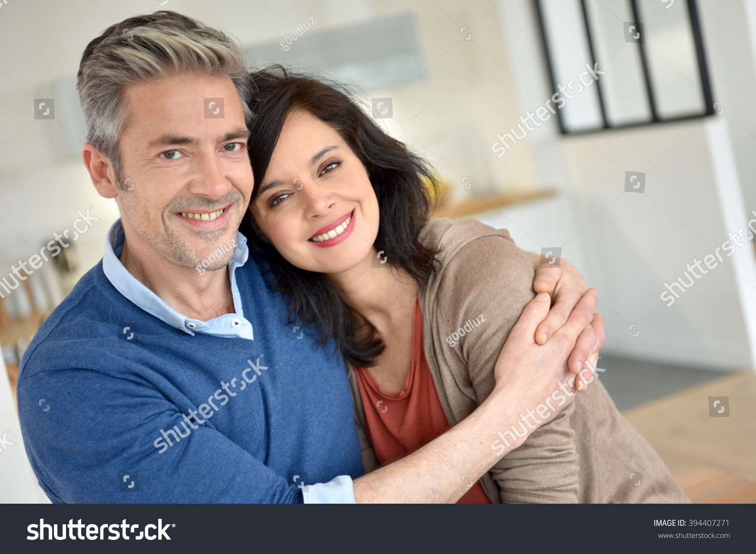 Middle-aged couple embracing each other #394407271