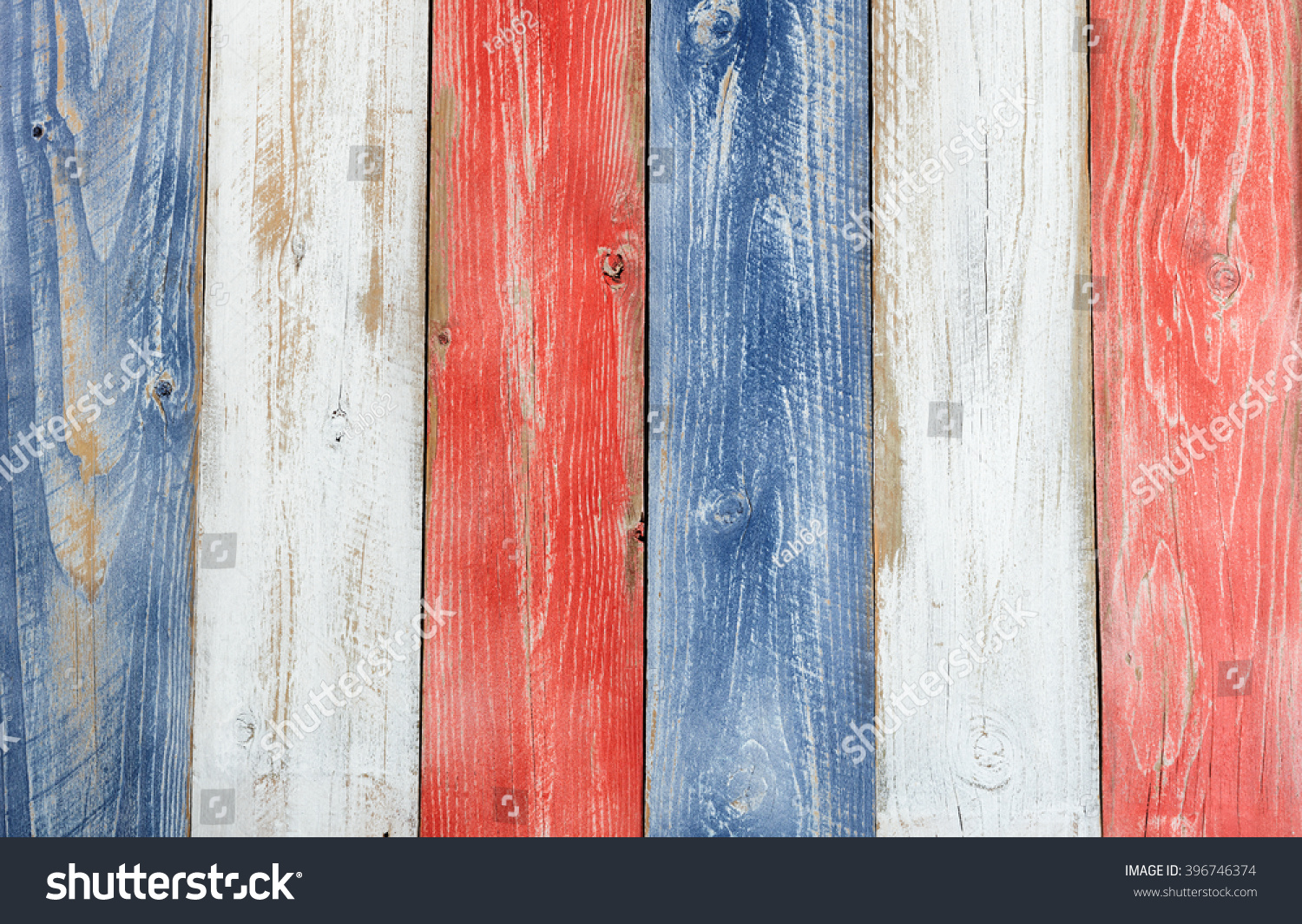 Stressed wooden boards painted red, white and blue for patriotic concept of United States of America. Layout in vertical format.  #396746374