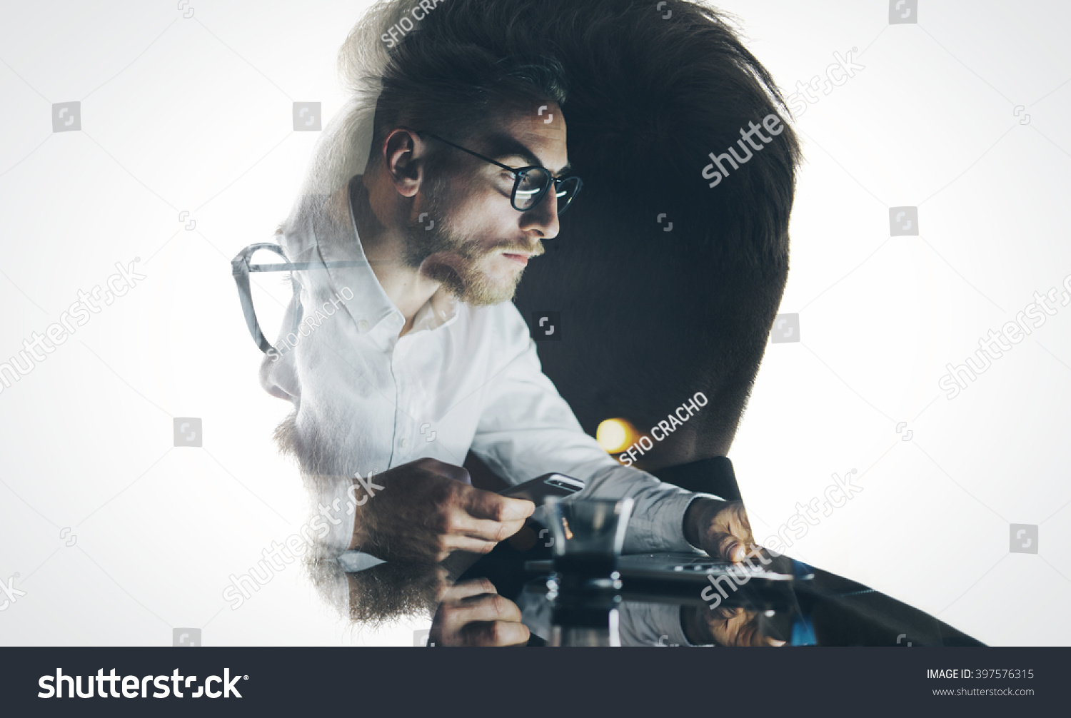Portrait of stylish bearded lawyer wearing glasses and looking city. Double exposure, businessman working laptop at night, texting smartphone background. Isolated white. Horizontal #397576315