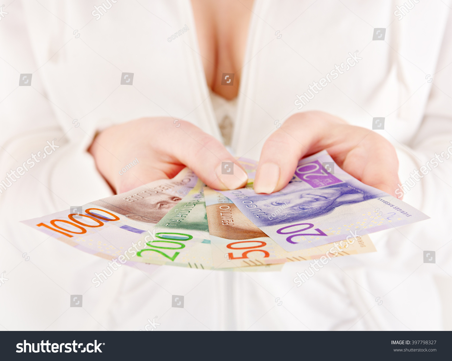 Woman holding new Swedish bank notes, NOTE: the new model. #397798327