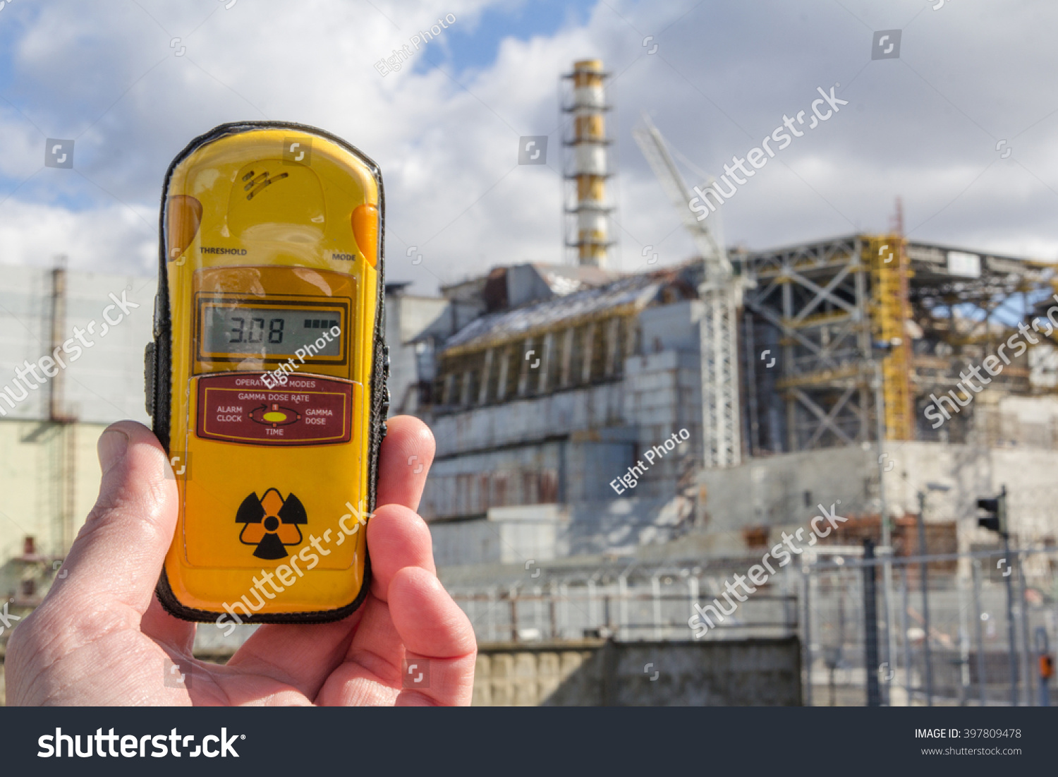 UKRAINE. Chernobyl Exclusion Zone. - 2016.03.19. Dosimeter and Nuclear Power Plant on the background #397809478