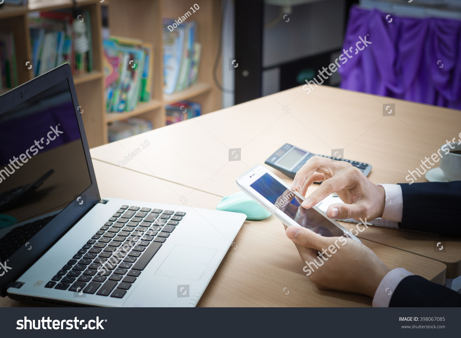 designer hand working with digital tablet and laptop and notebook on wooden desk in office
 #398067085