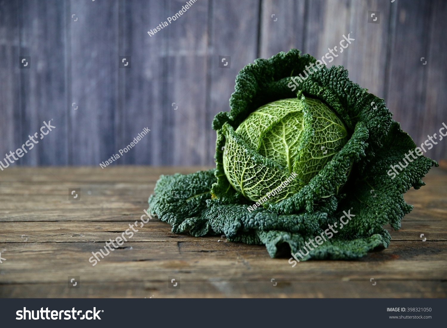 Raw savoy cabbage on wooden and grey background #398321050
