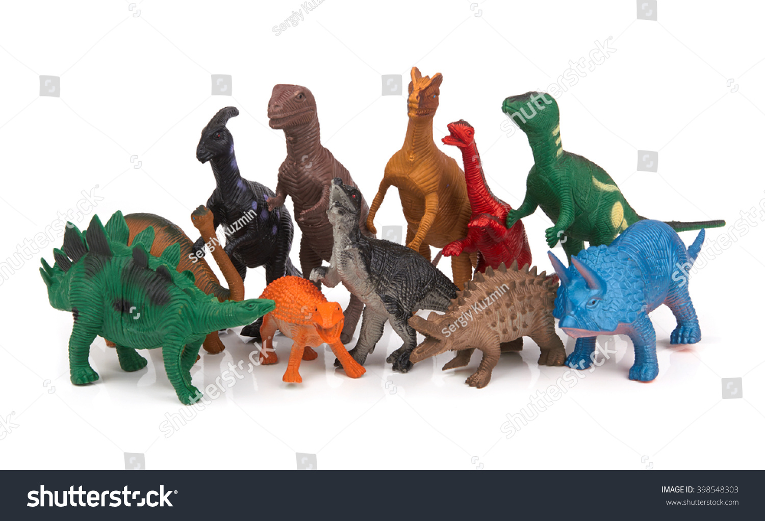 Group of toy dinosaurs on white background #398548303