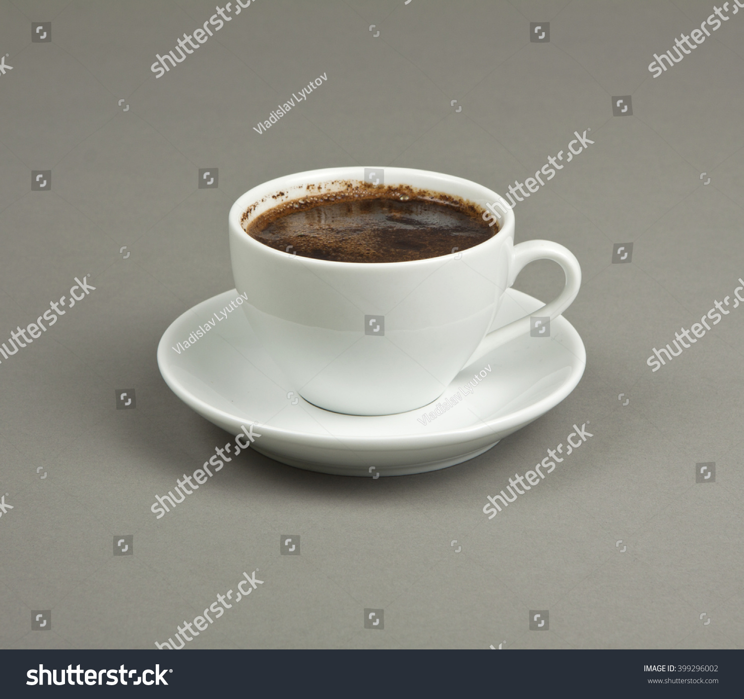 Cup of coffee and saucer on a gray background #399296002