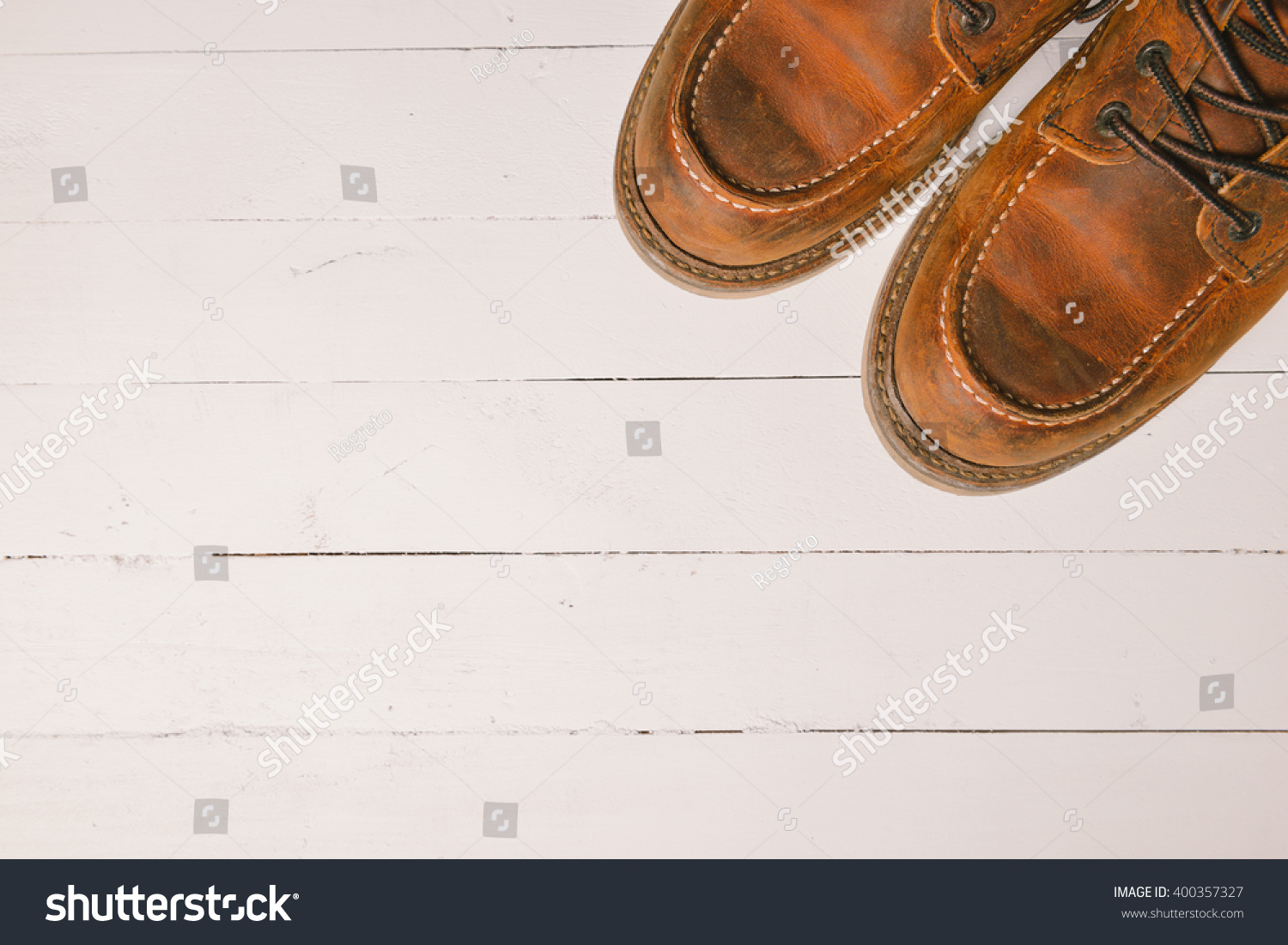 Old leather boot traditional leather style on wooden background with filter vintage style effect #400357327