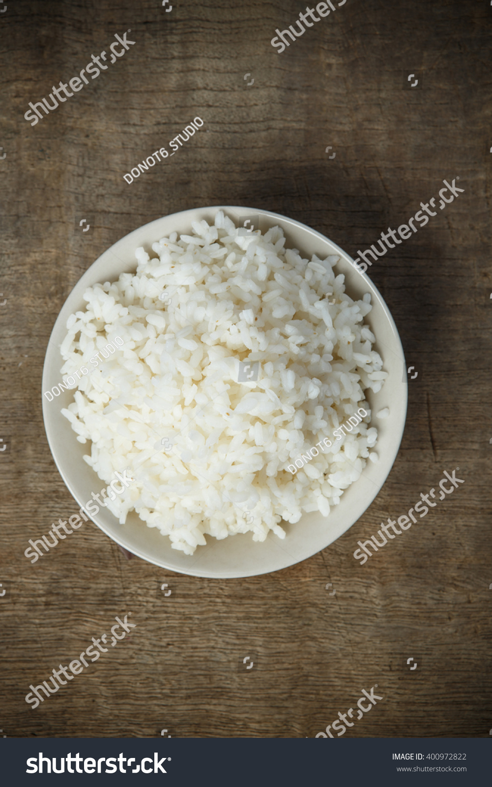 Cooked rice isolated on wooden background #400972822